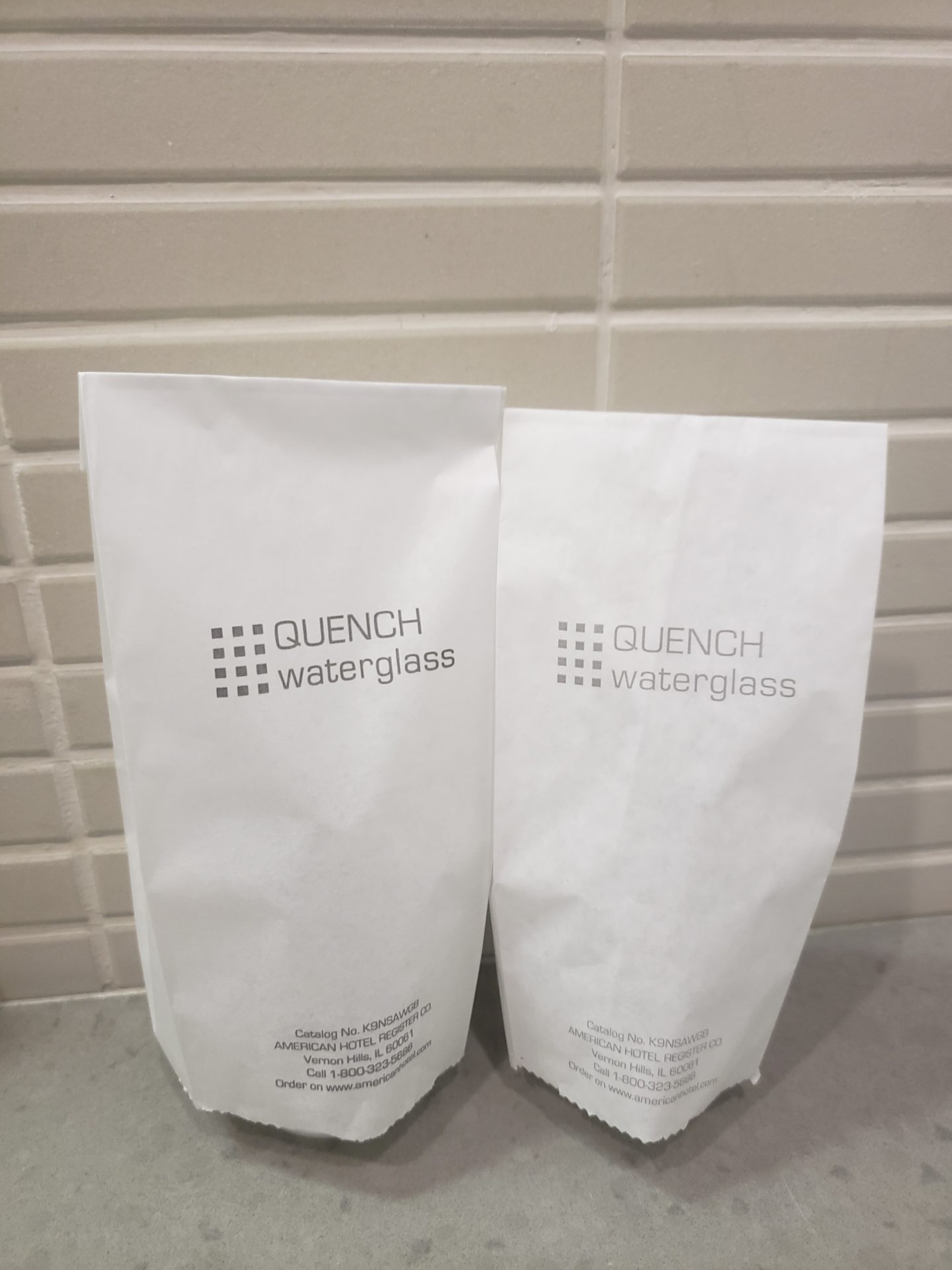 two white bags with text on them
