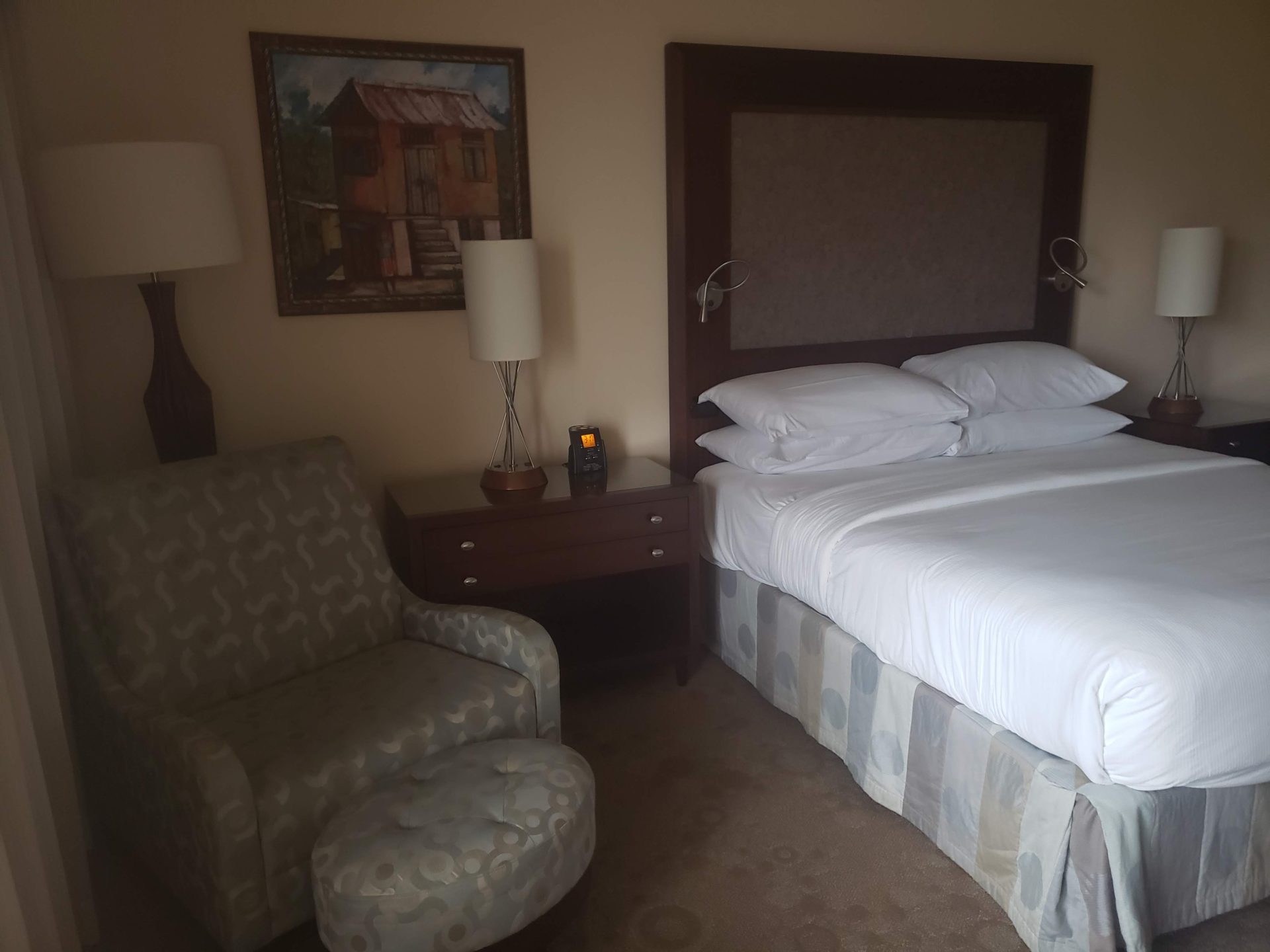 a bed and chair in a hotel room