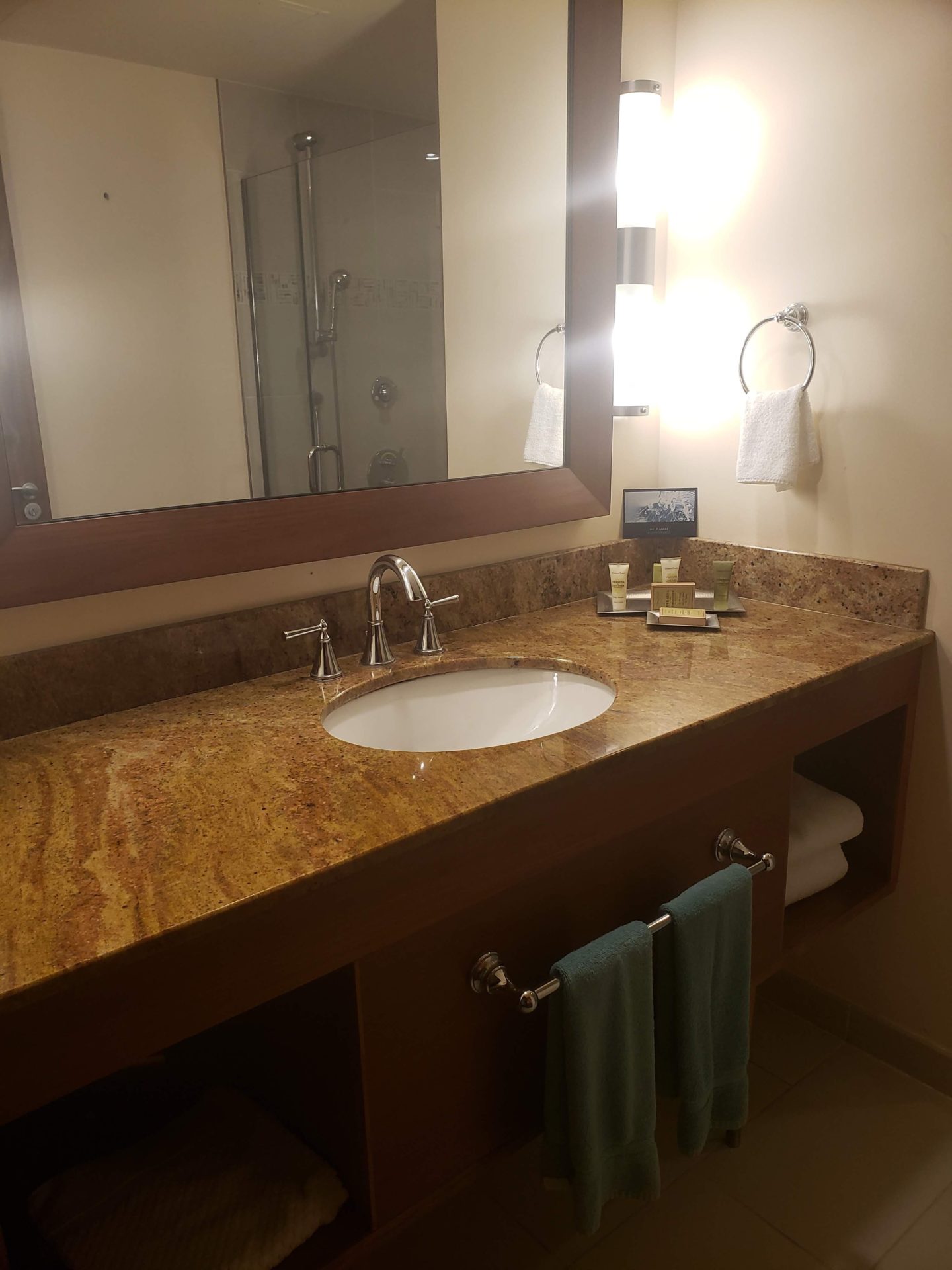 a bathroom with a marble countertop and a mirror