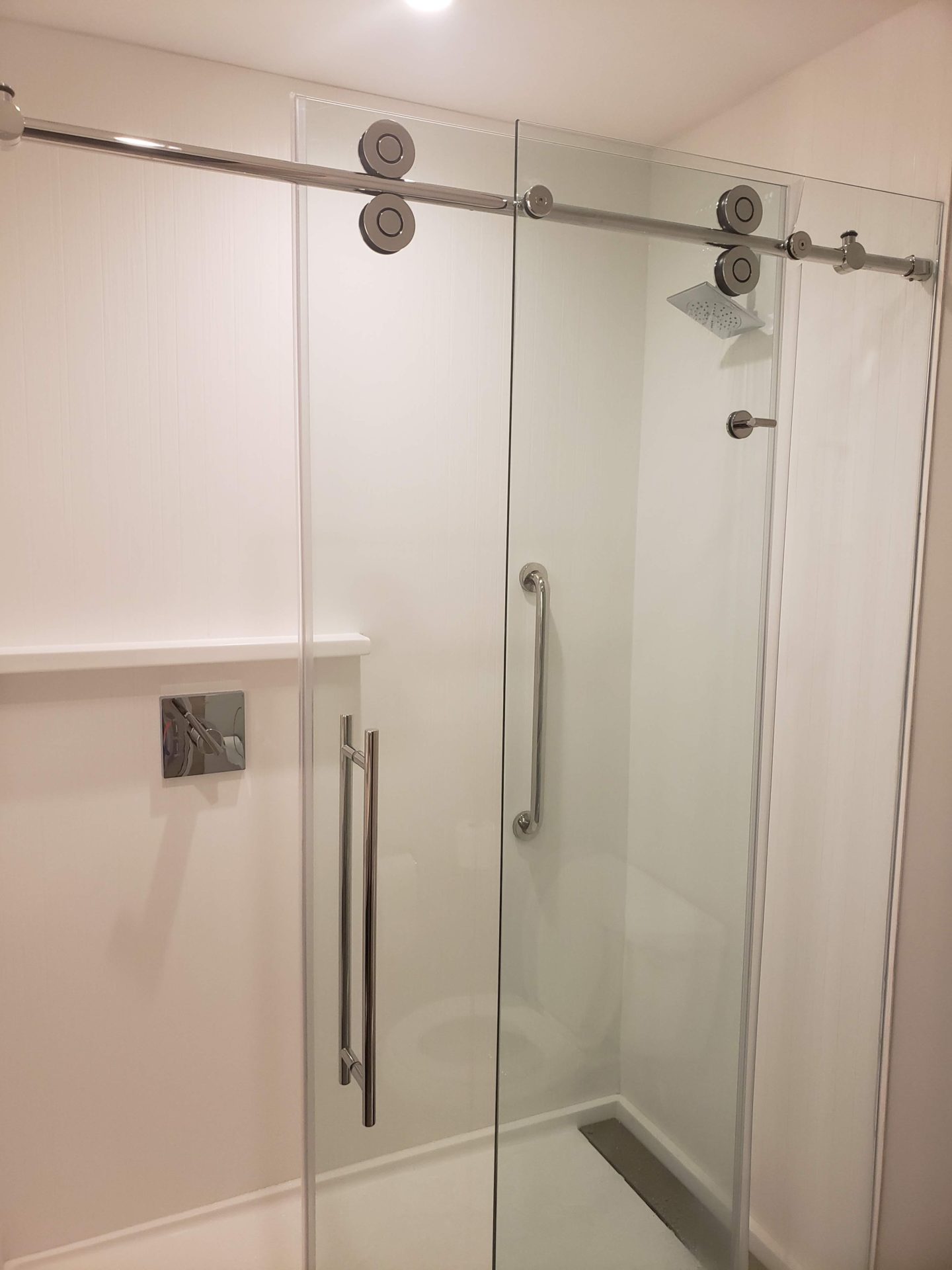 a glass shower door with a shower head