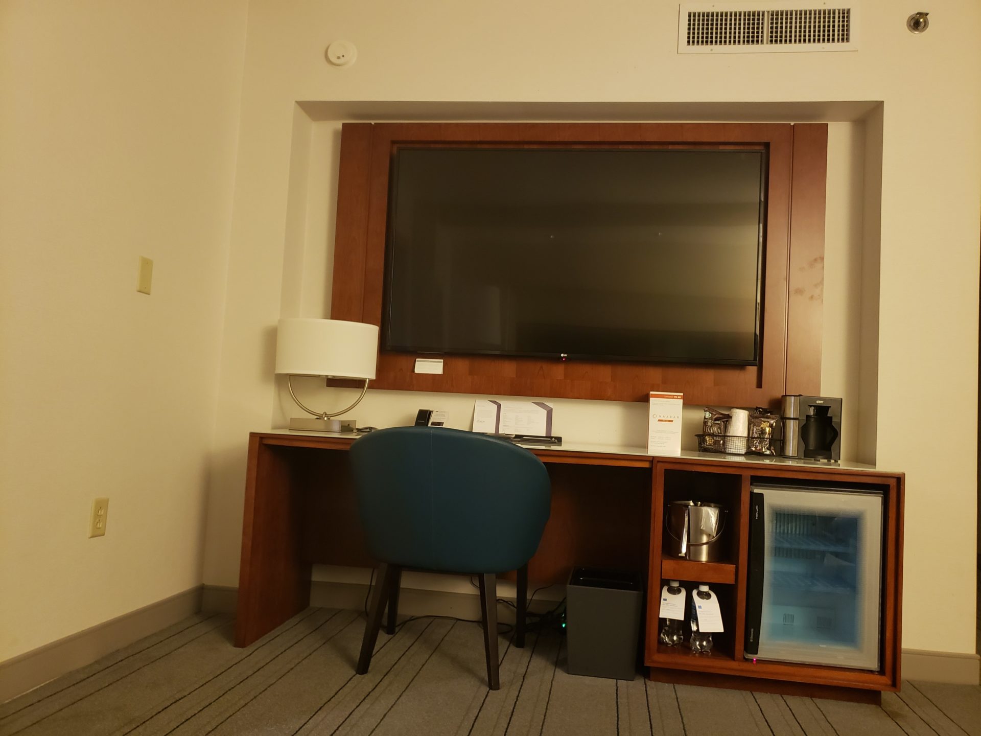 a desk with a chair and a tv in a room