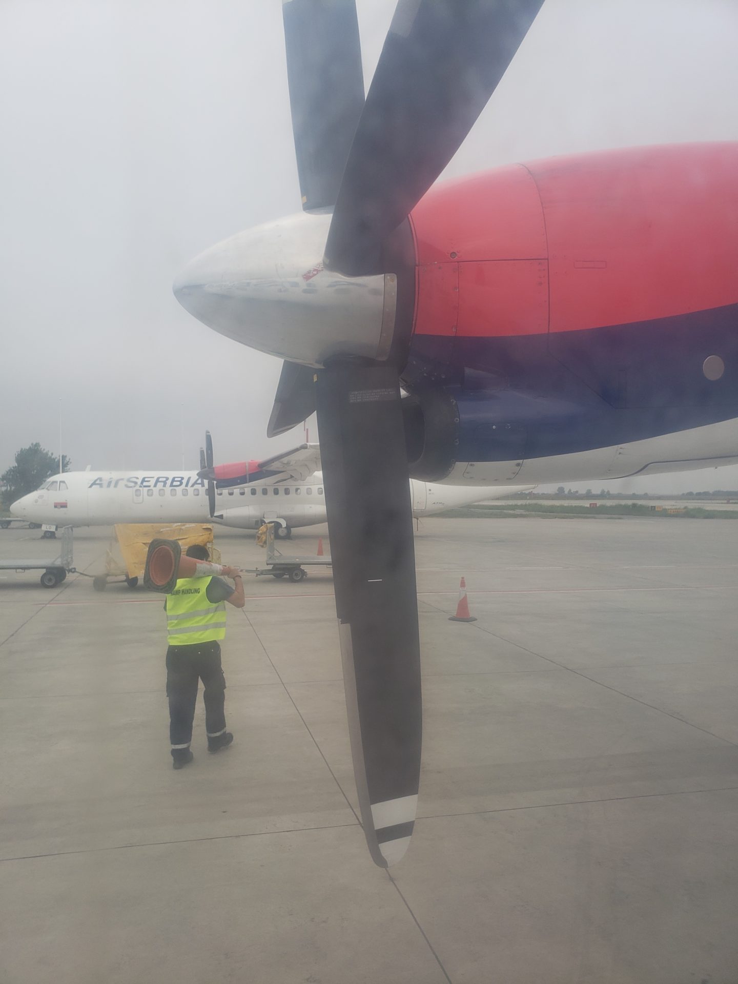 a man standing next to a propeller of a plane