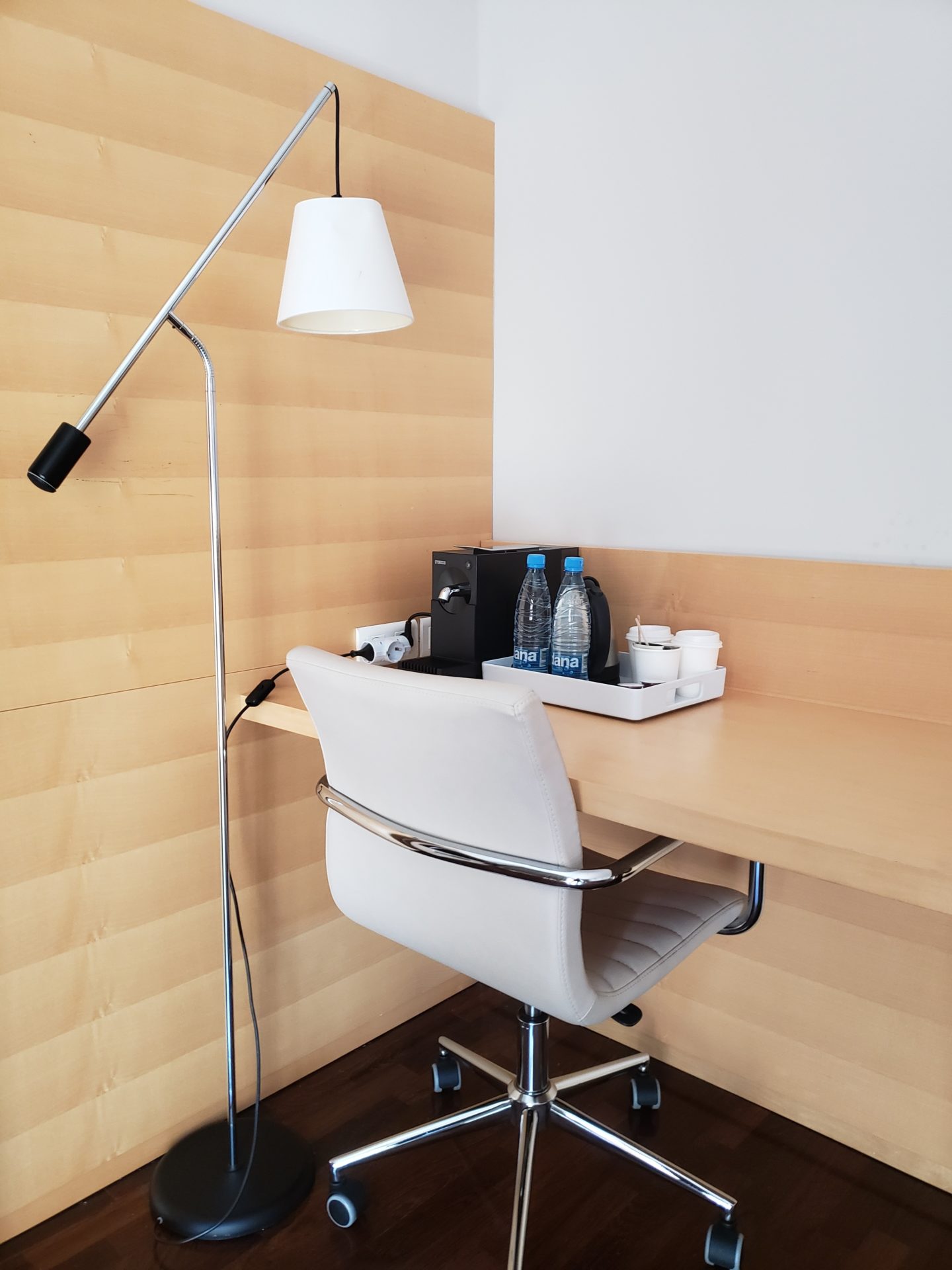 a desk with a chair and a lamp
