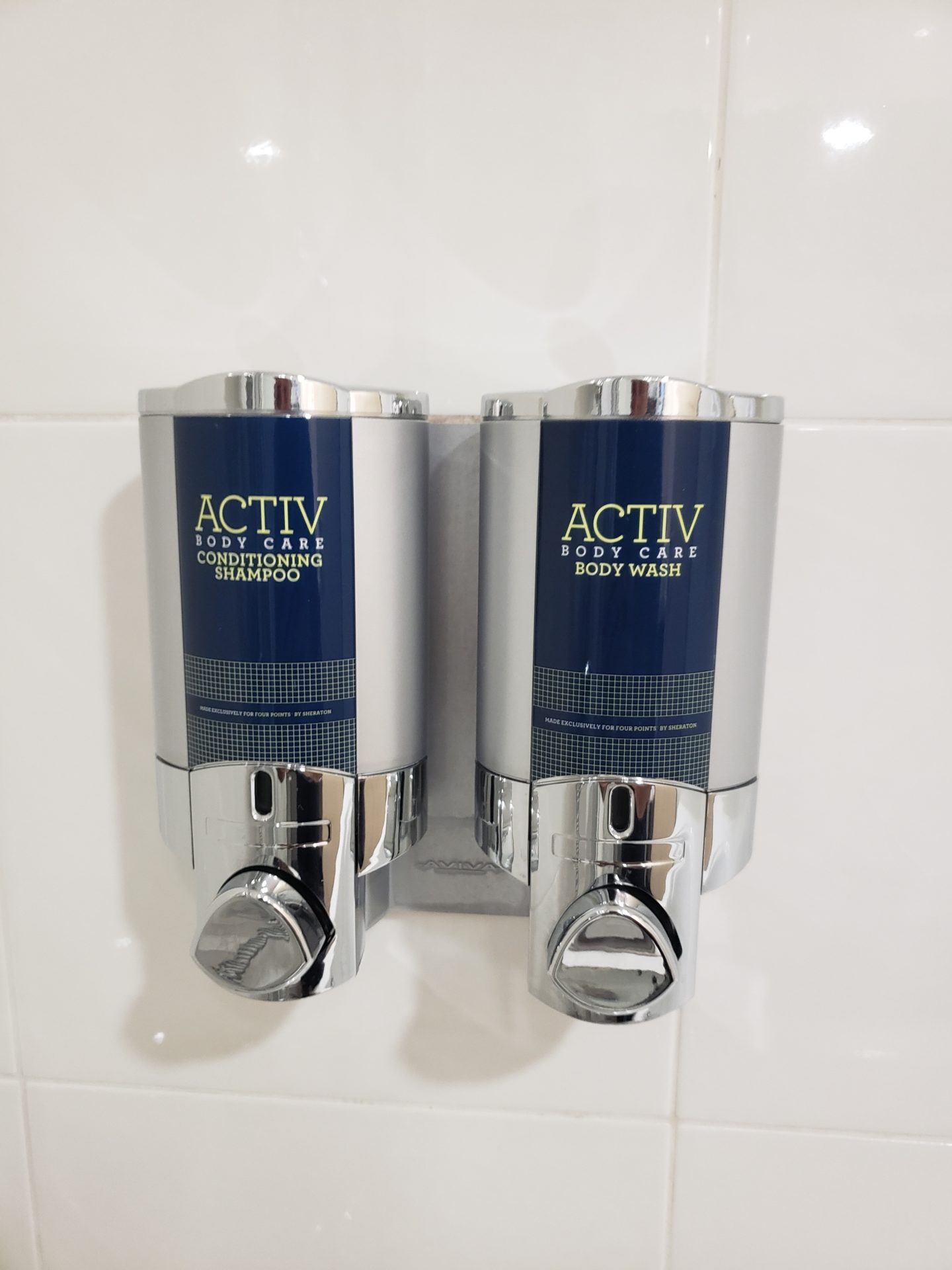 a two soap dispensers on a wall