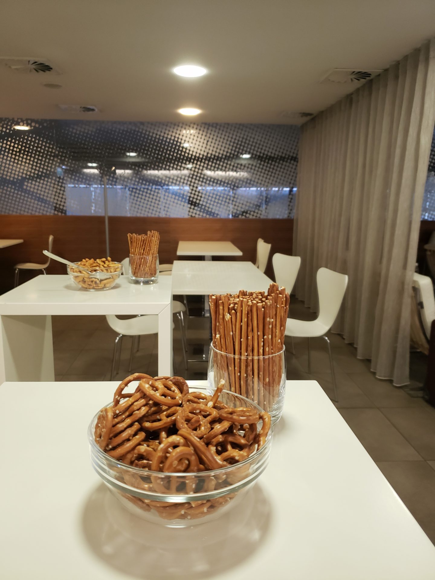 a bowl of pretzels and sticks on a table