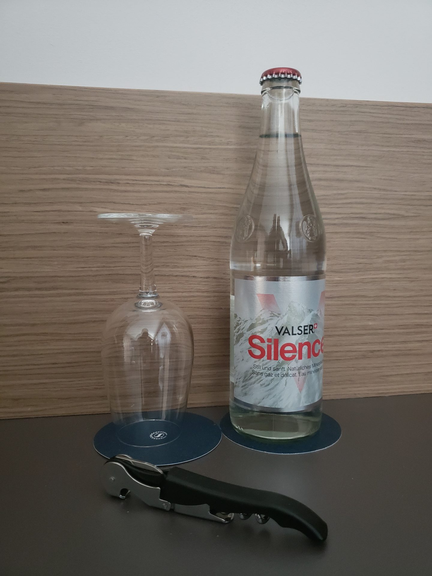 a bottle and glass next to a bottle