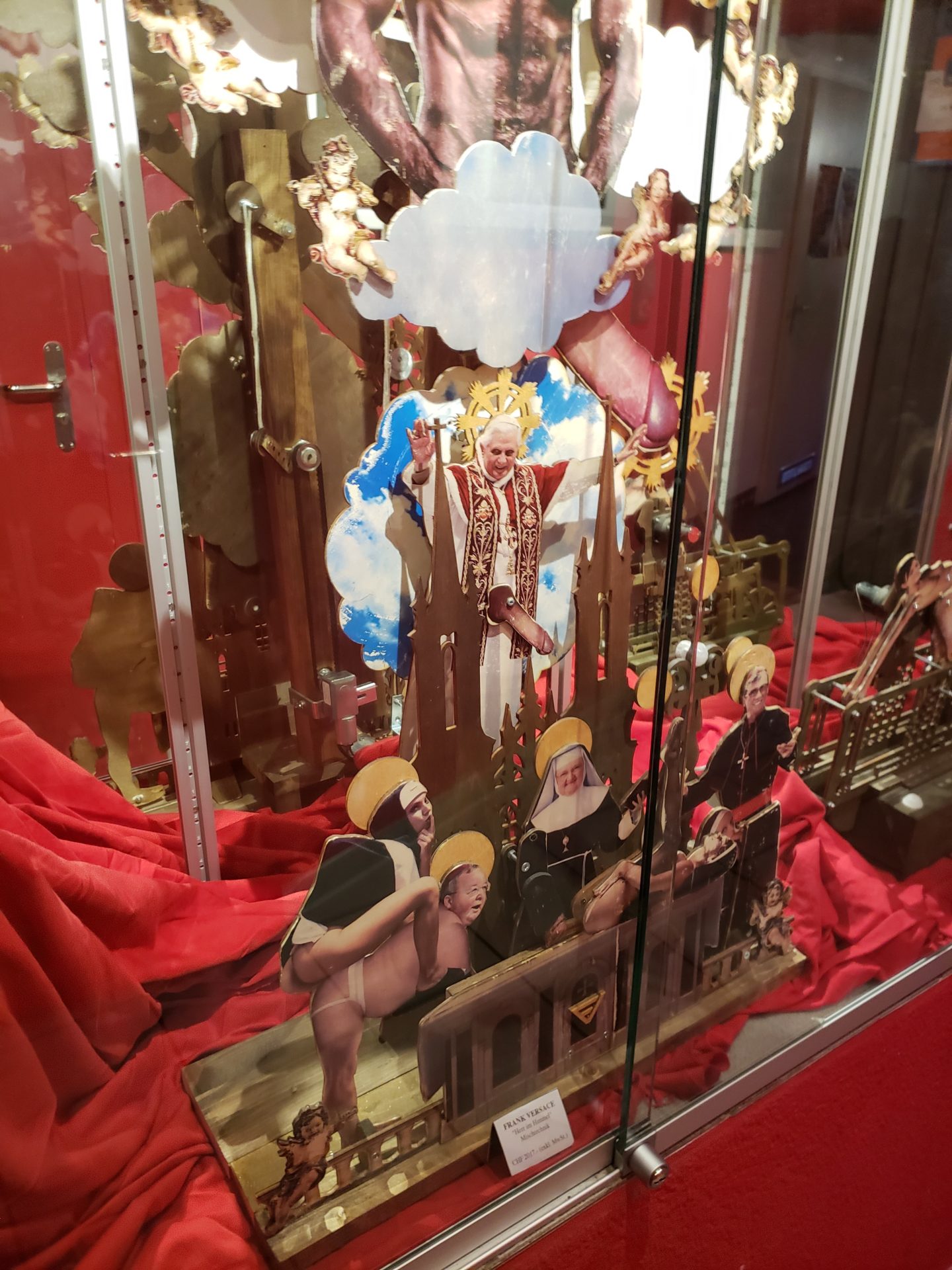 a display case with a cut out of a cardboard cutout of a religious figure