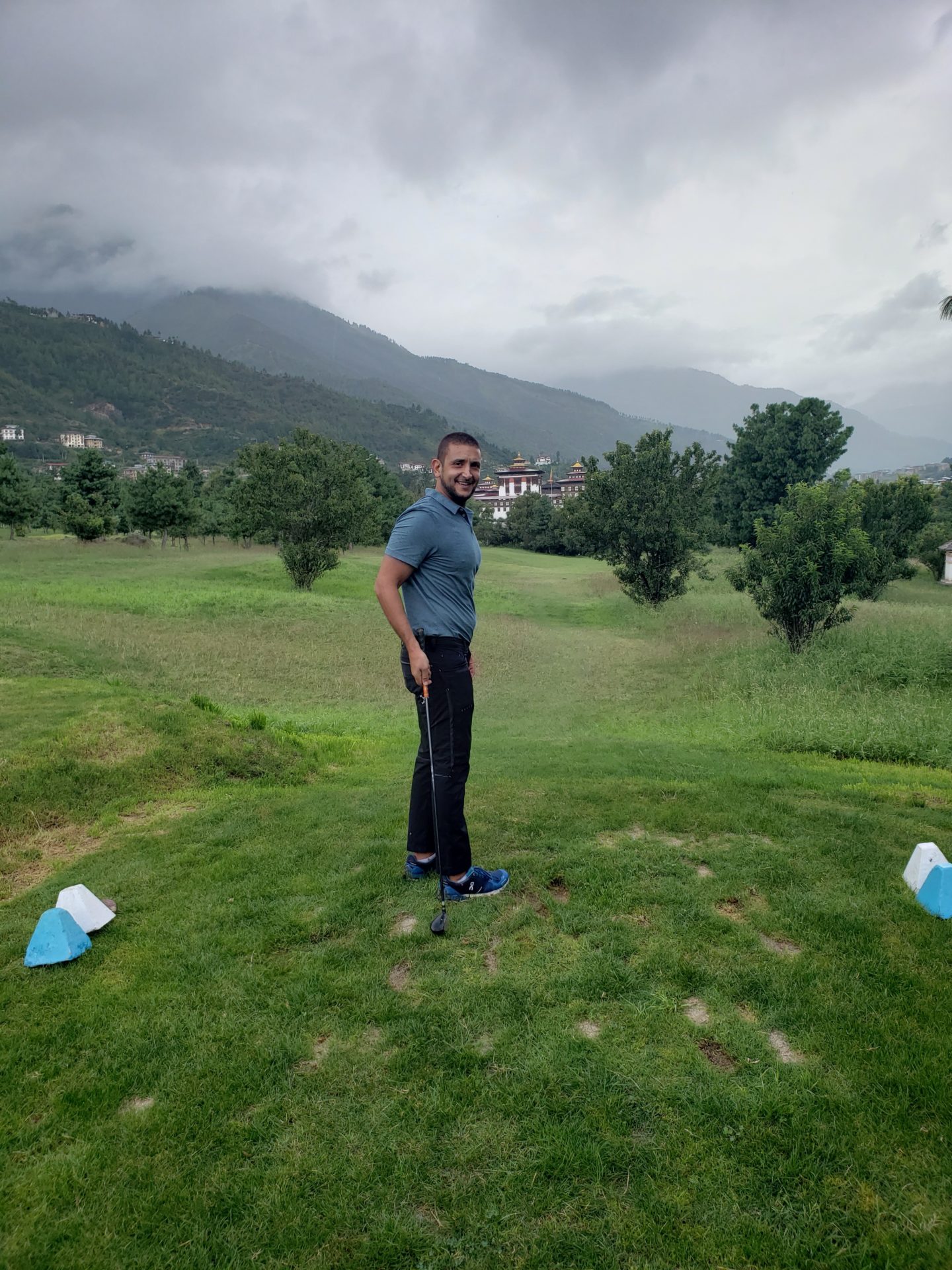 a man standing in a golf course