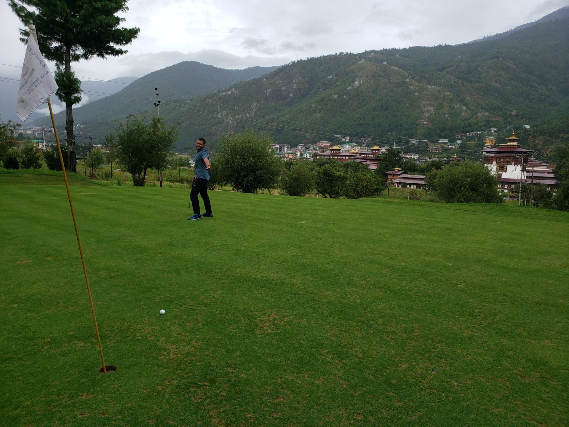 a man standing on a golf course