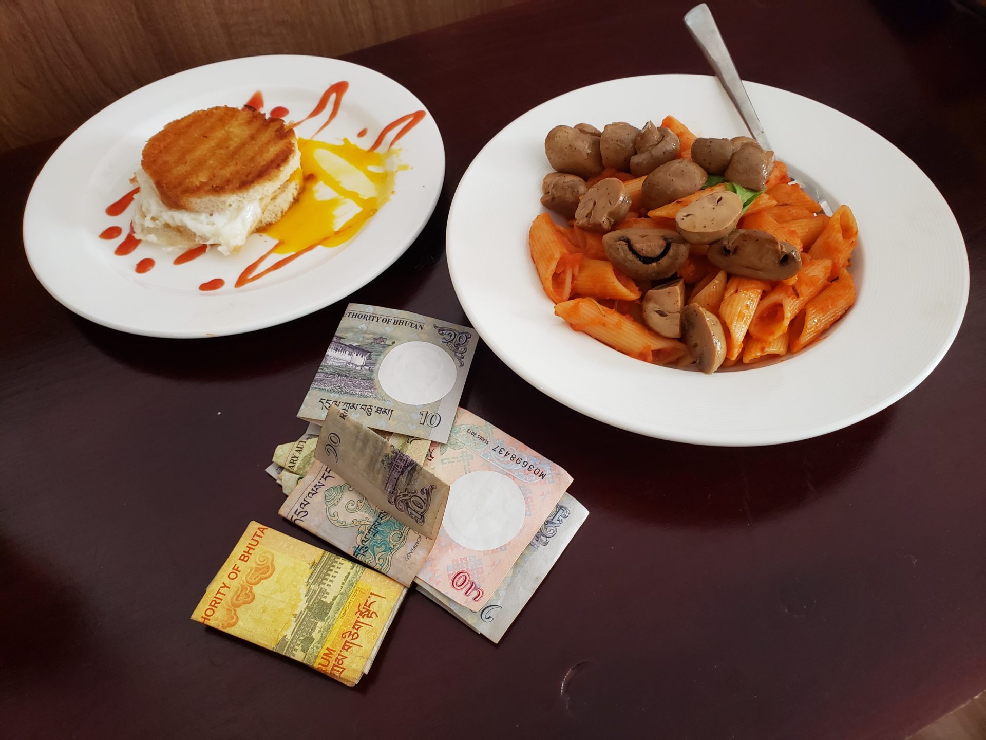 a plate of food and money on a table