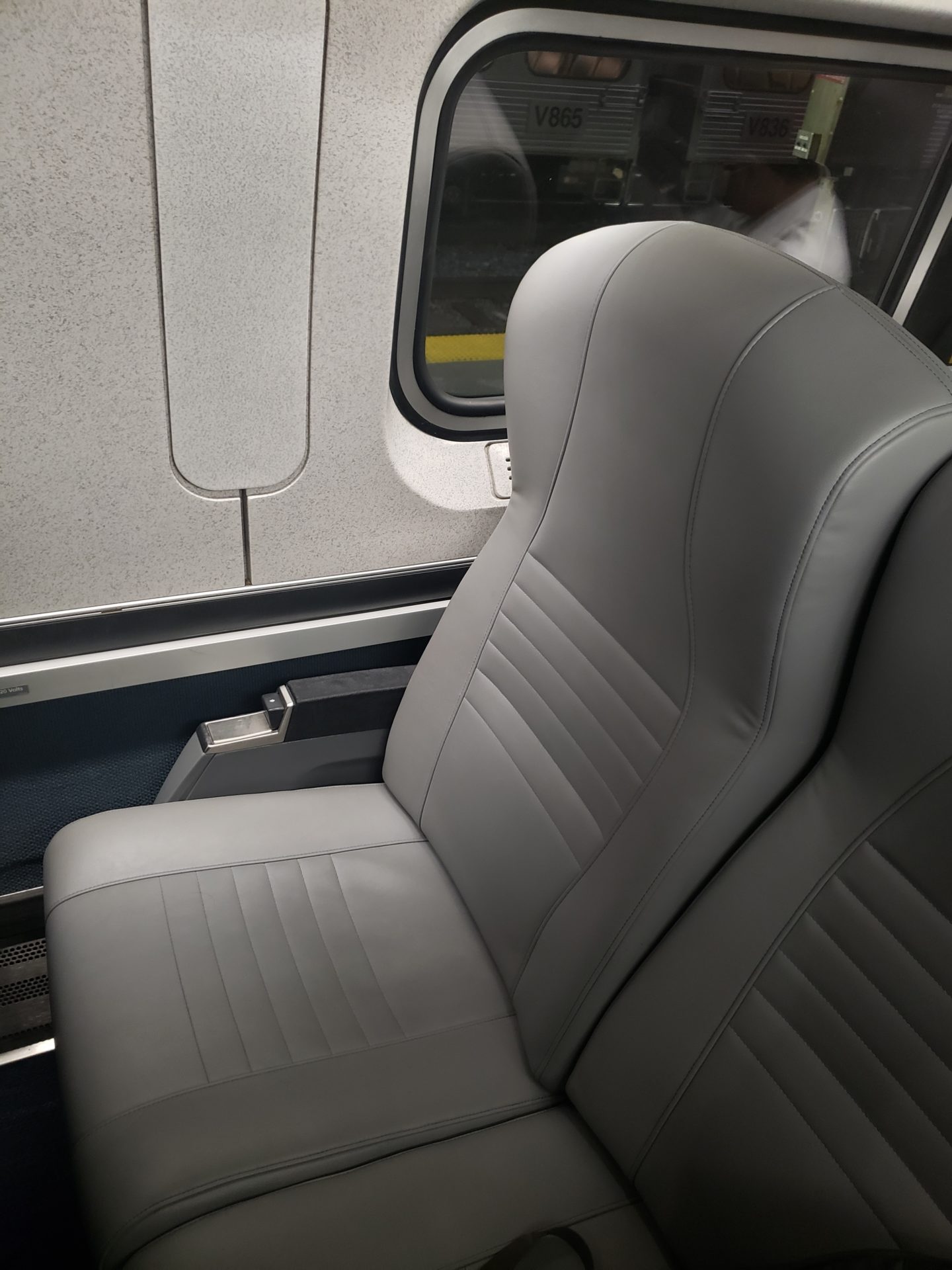 a grey seat in a train