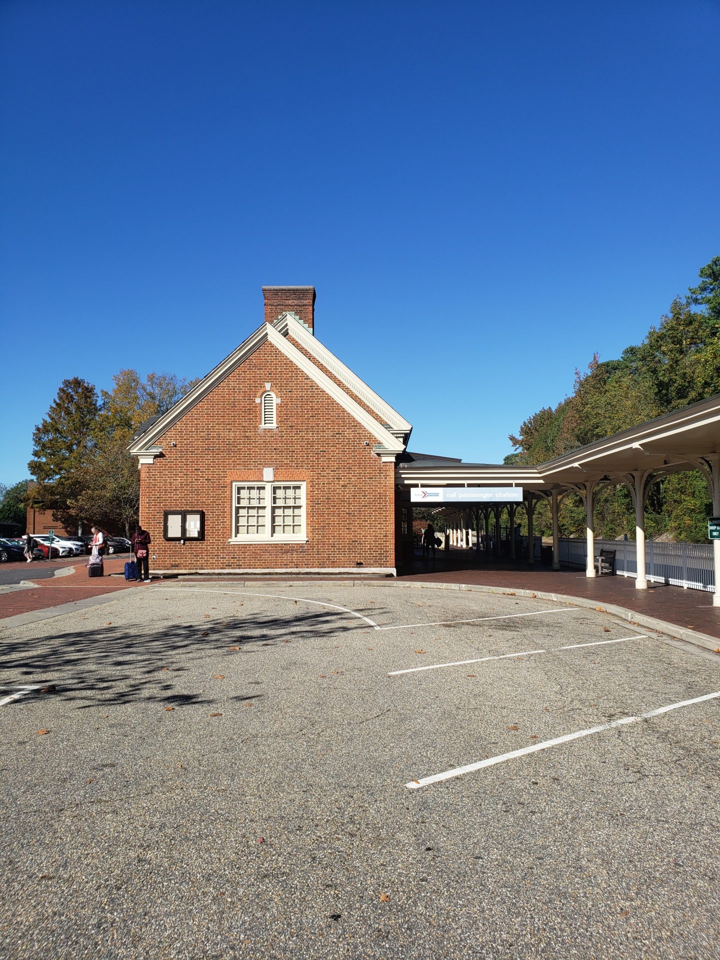 a brick building with a covered parking lot