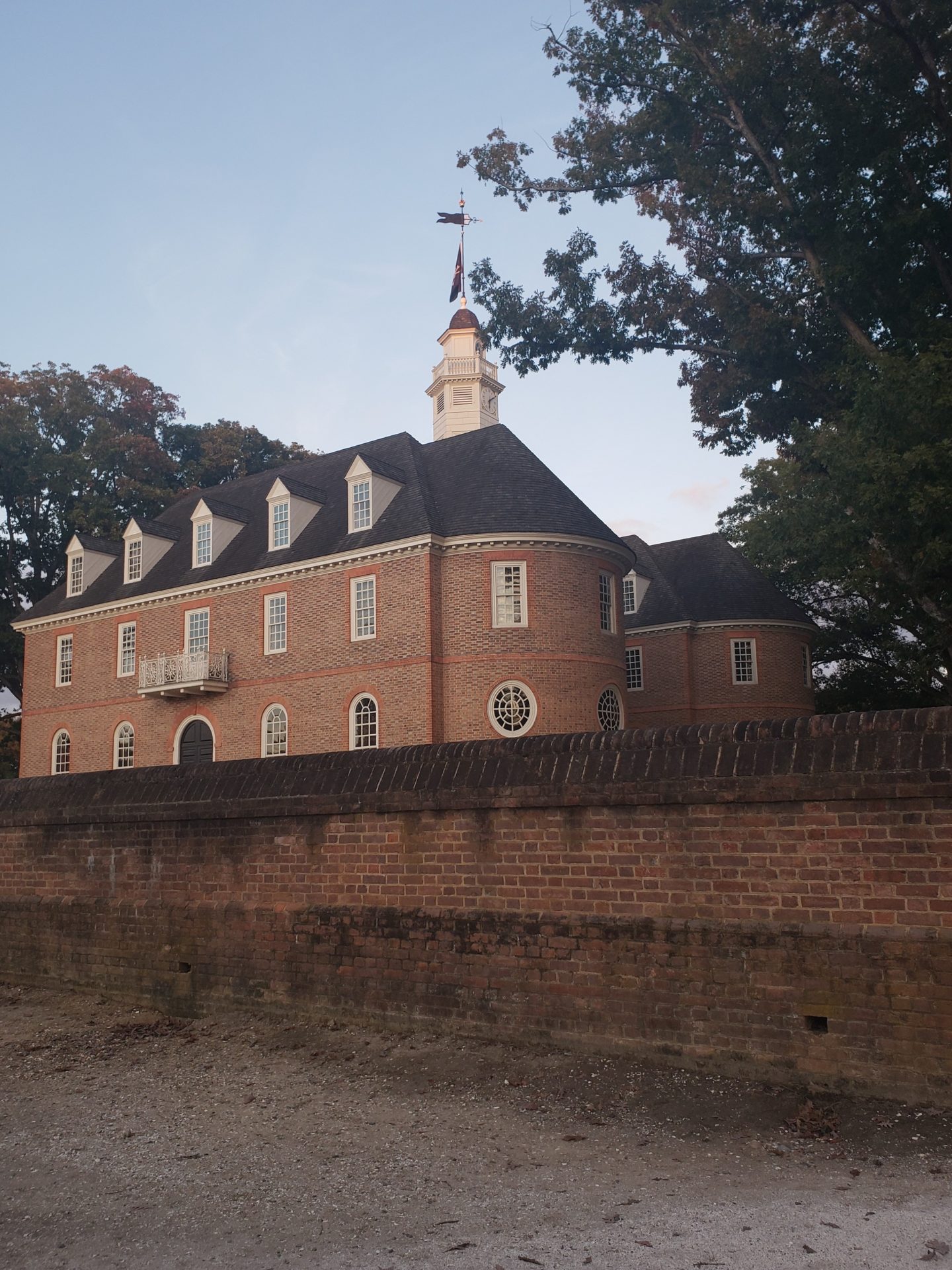 a brick building with a flag on top