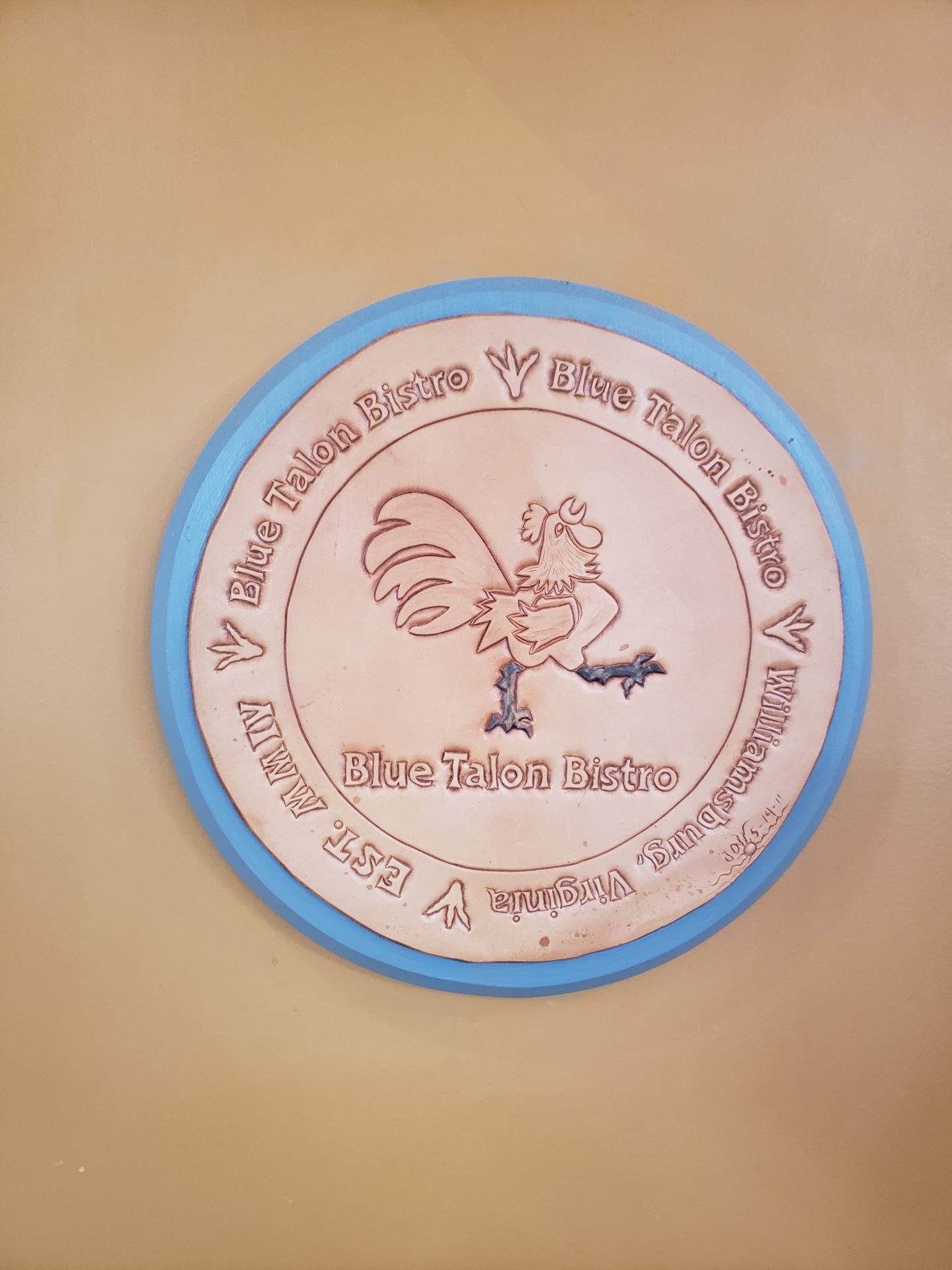 a circular sign with a rooster on it