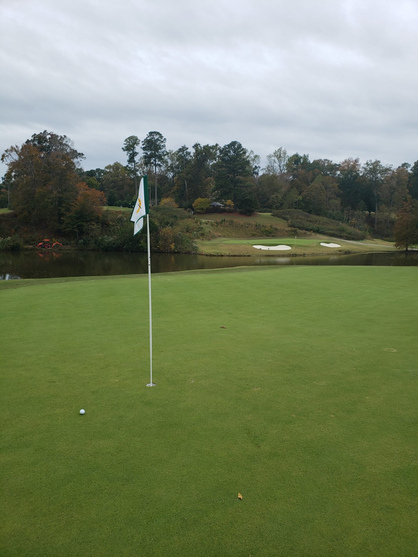 a golf course with a flag on the flagpole
