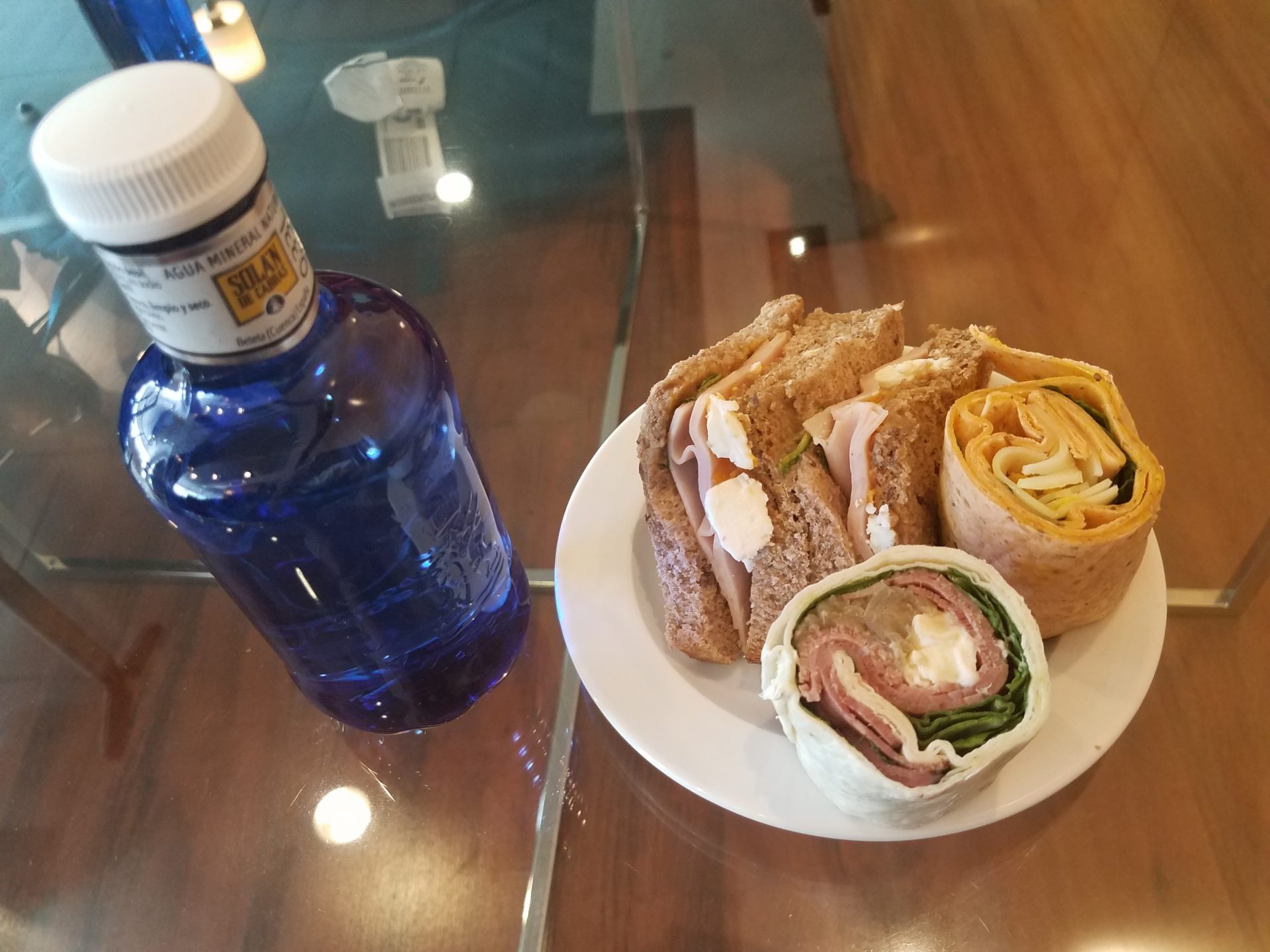a plate of sandwiches and a bottle of water