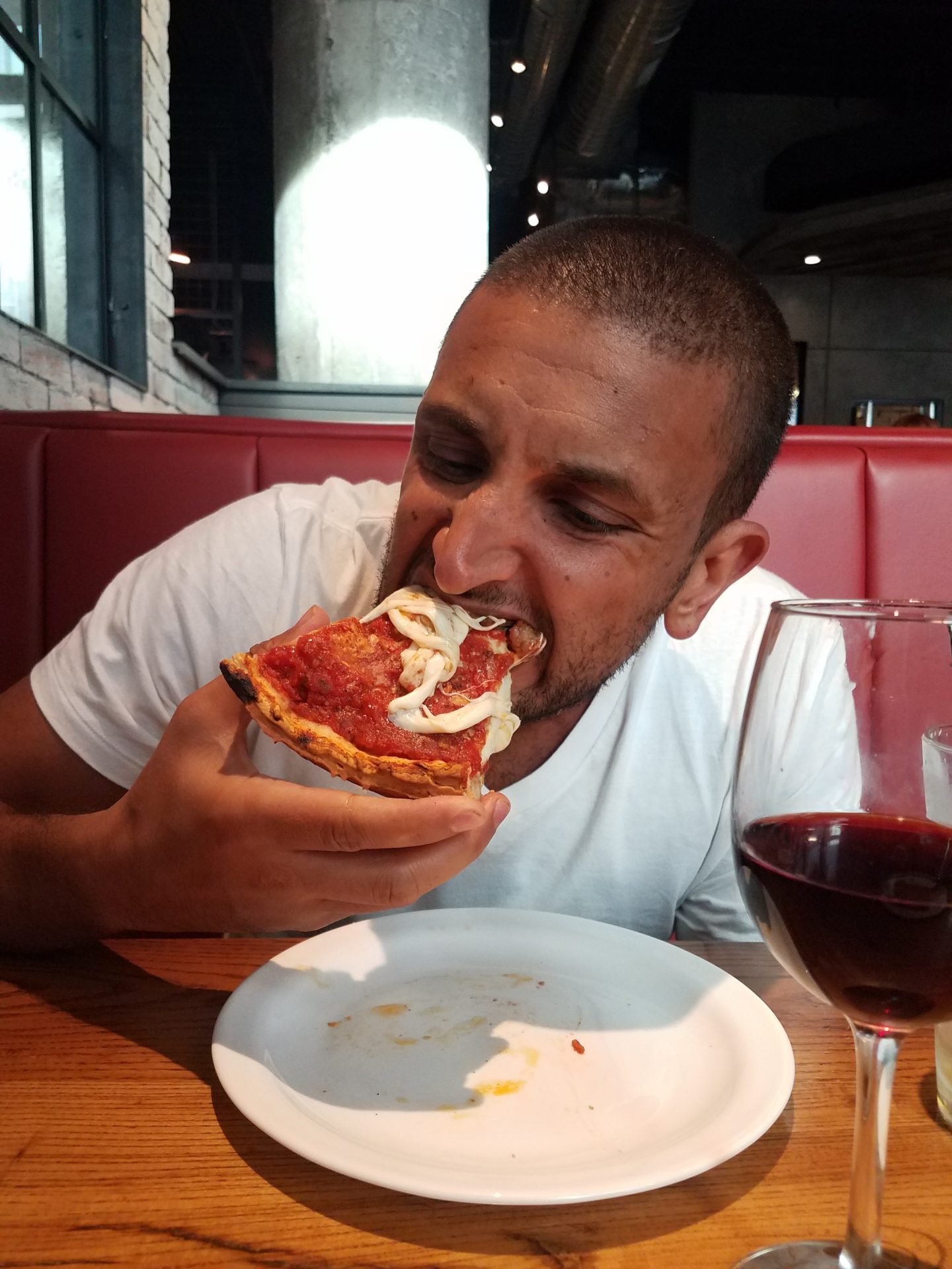 a man eating a slice of pizza