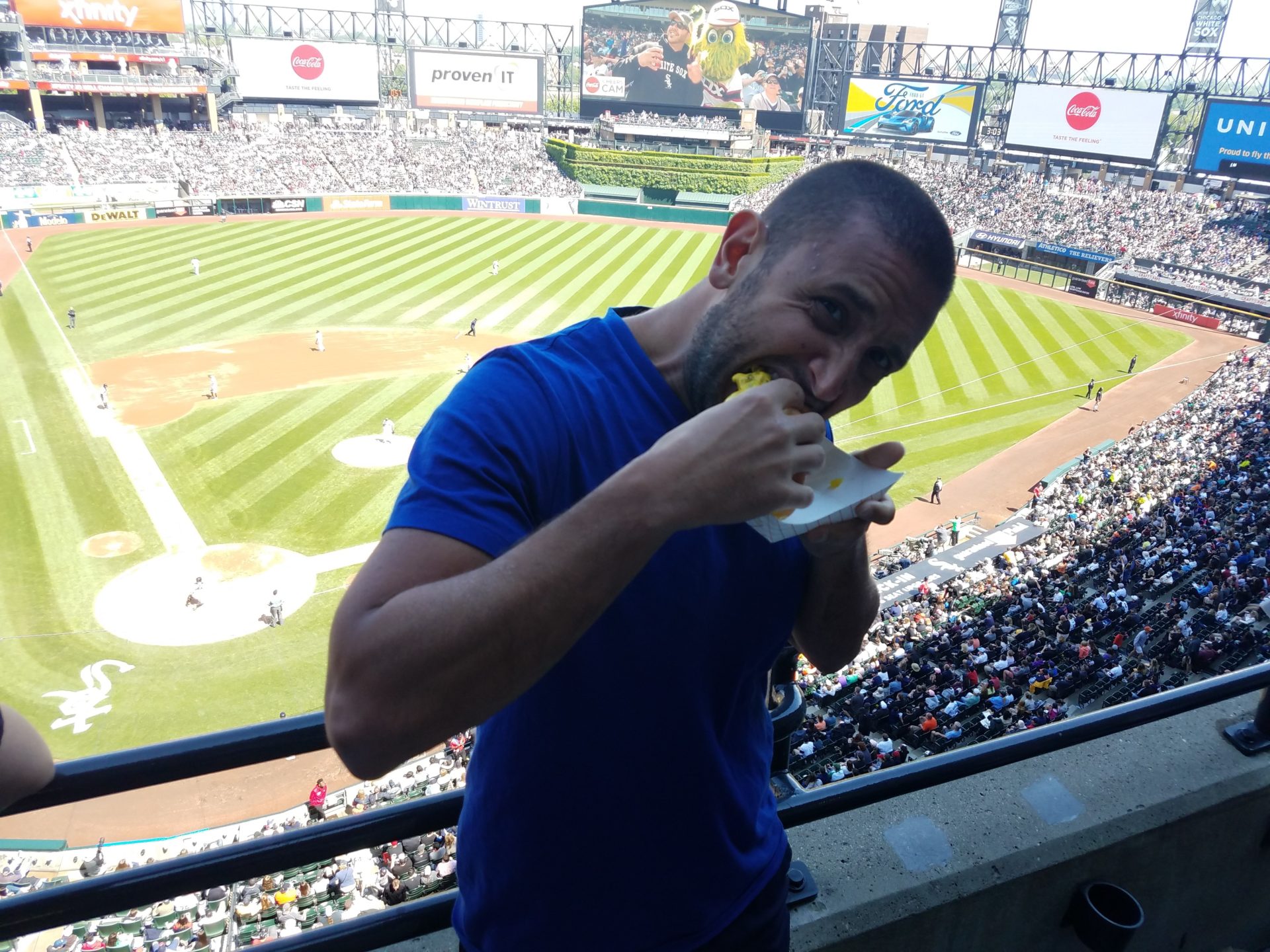 a man eating food in a stadium