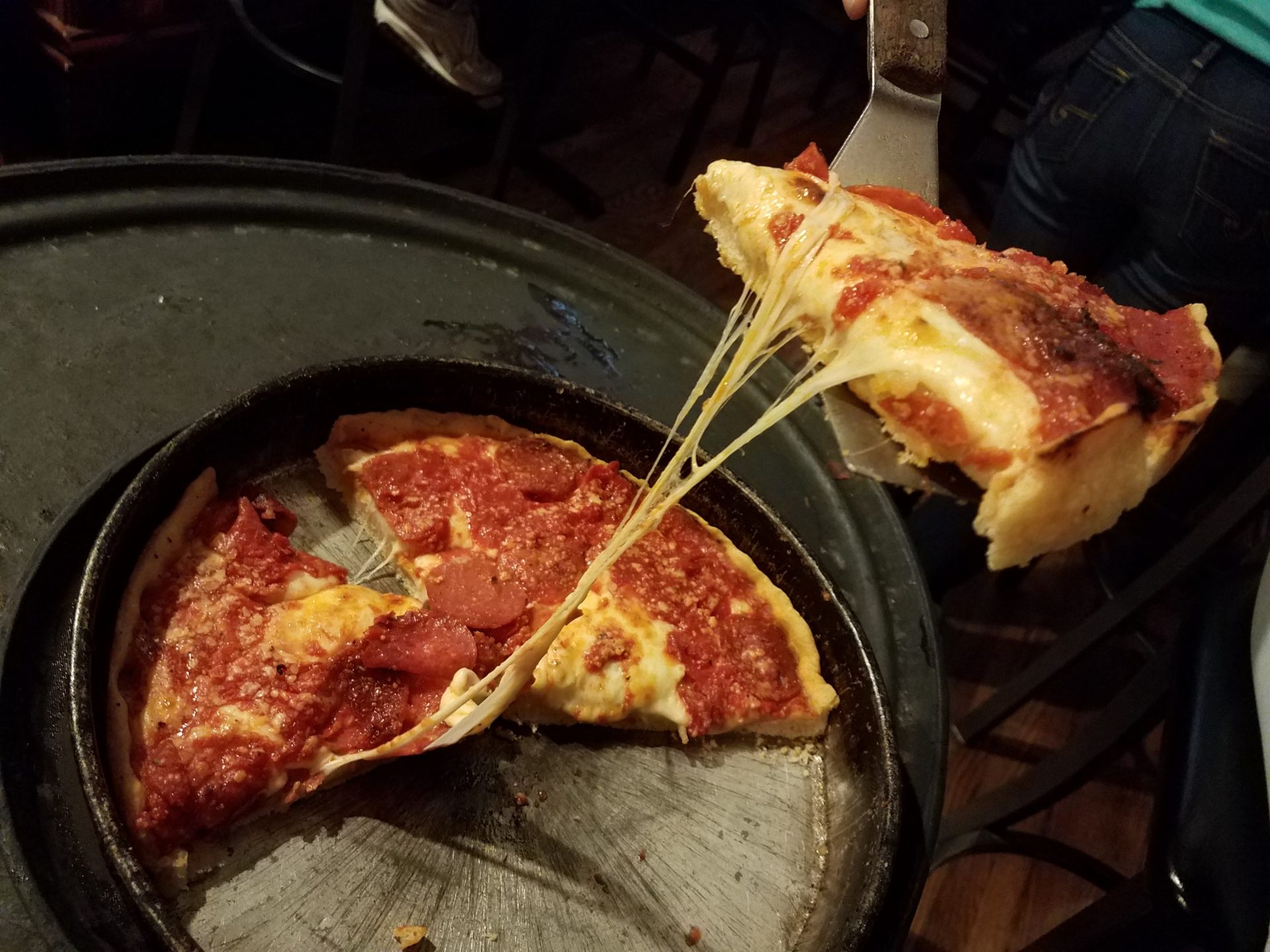 a pizza being cut in half