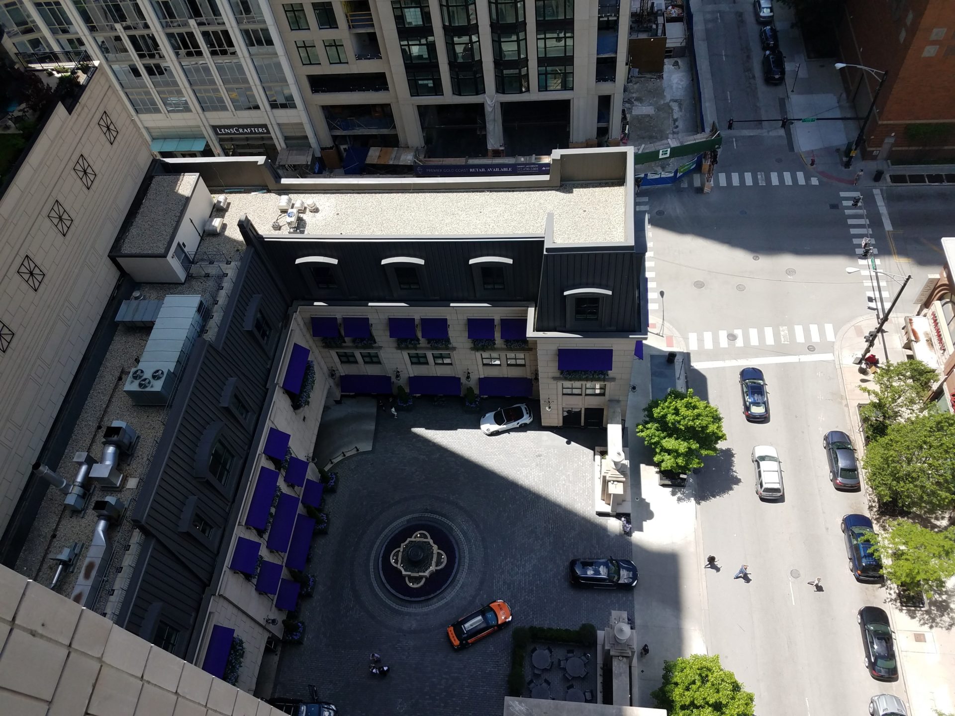 a view from above of a building with cars and a street