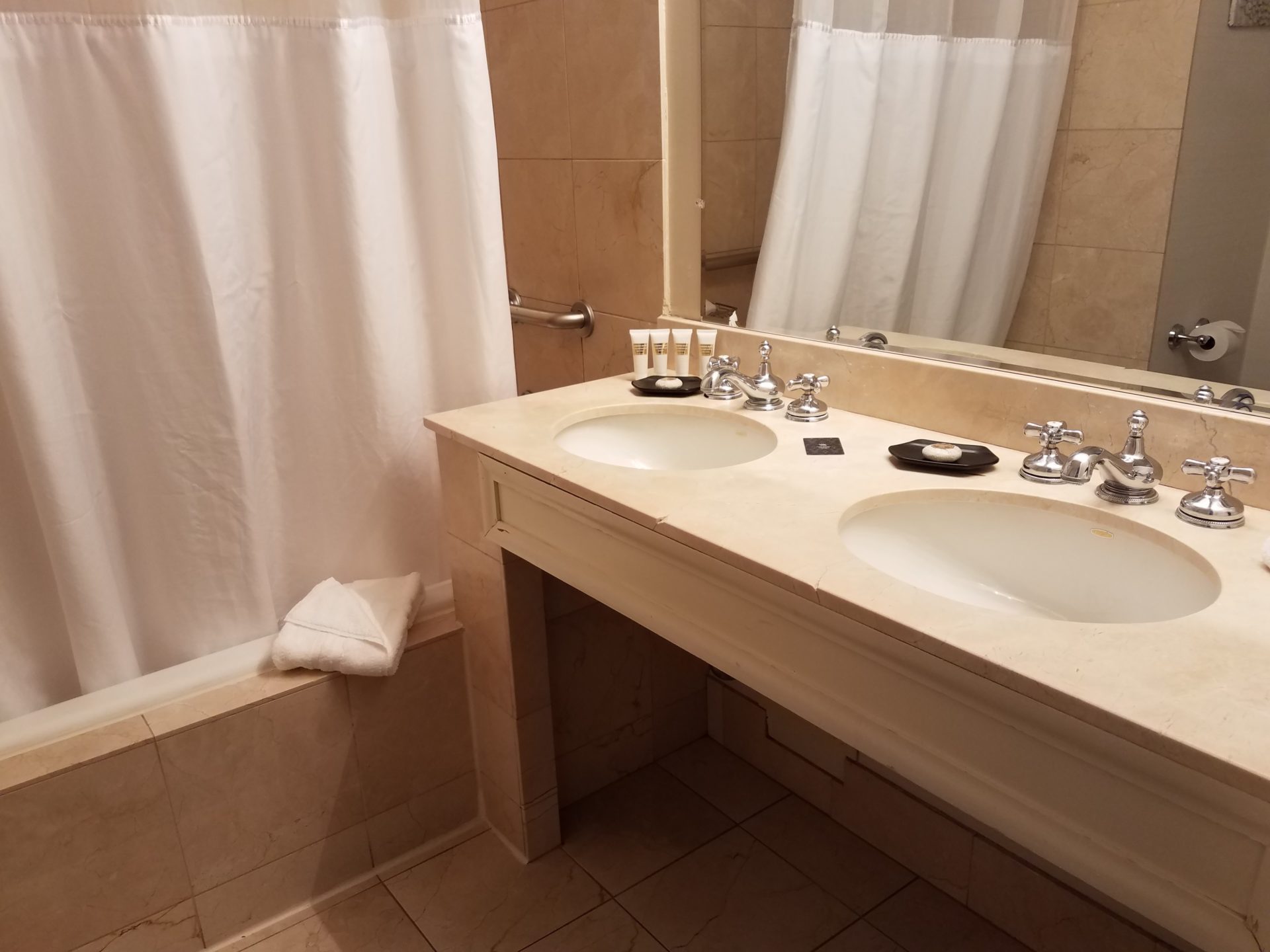 a bathroom with a shower curtain and two sinks