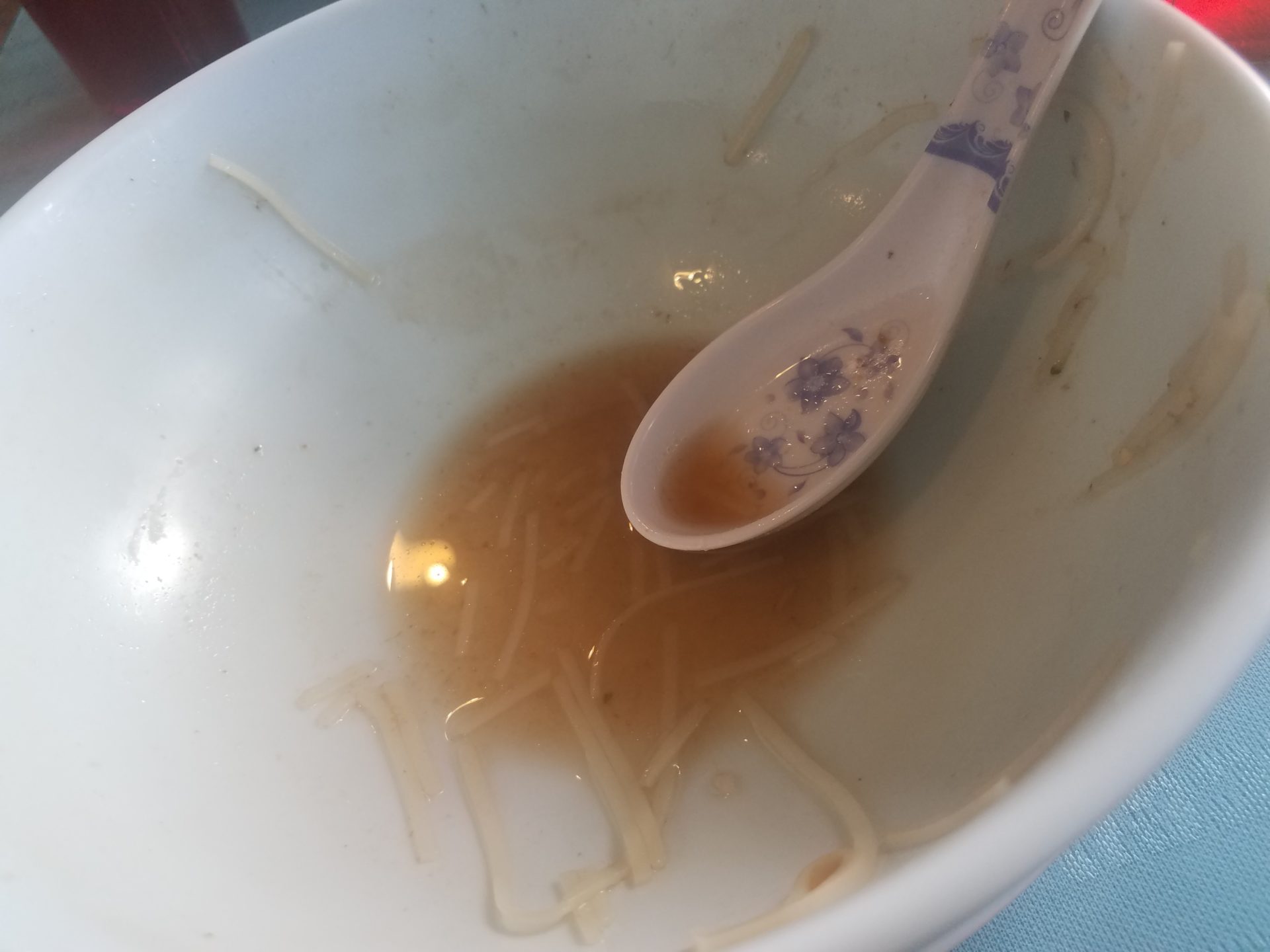 a bowl of noodles with a spoon