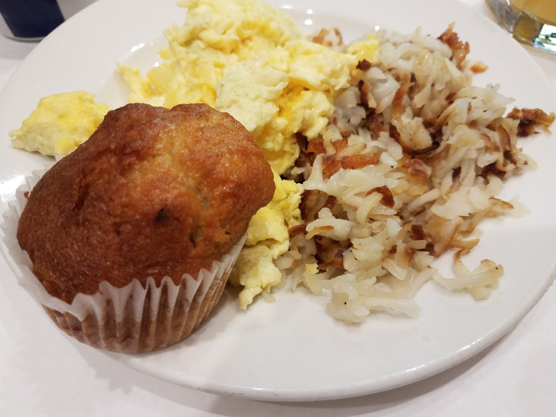 a muffin and eggs on a plate