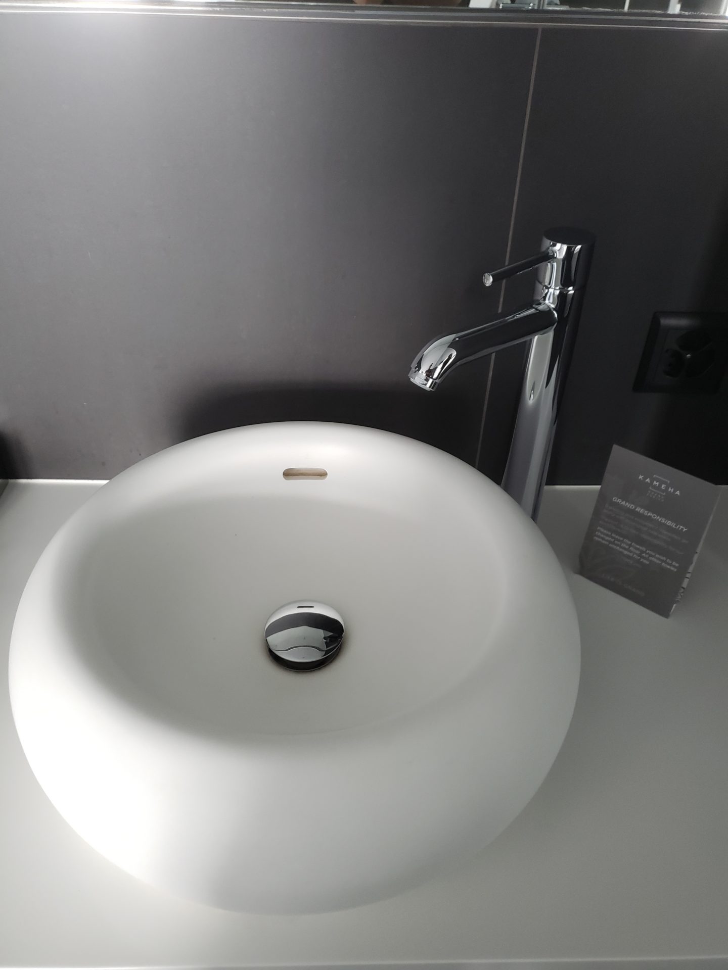 a white sink with a silver faucet