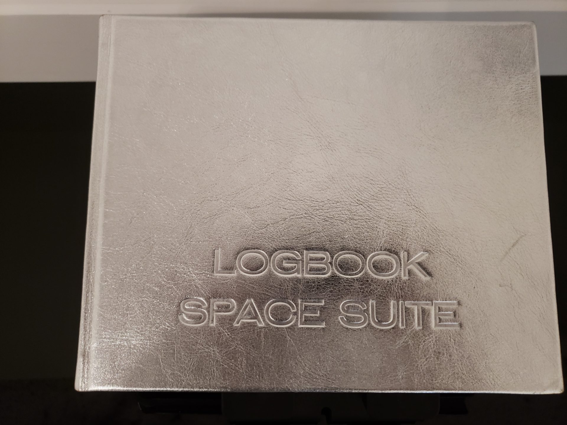 a silver book with text on it