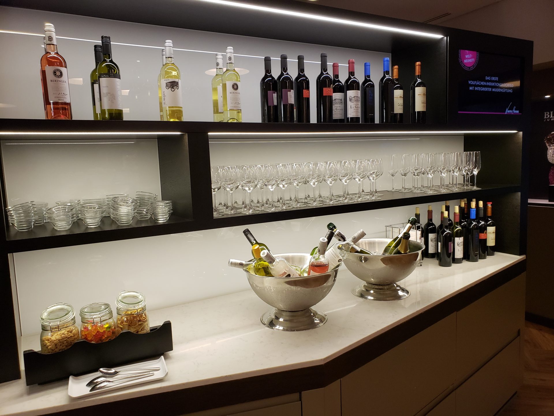 a bar with wine bottles and glasses