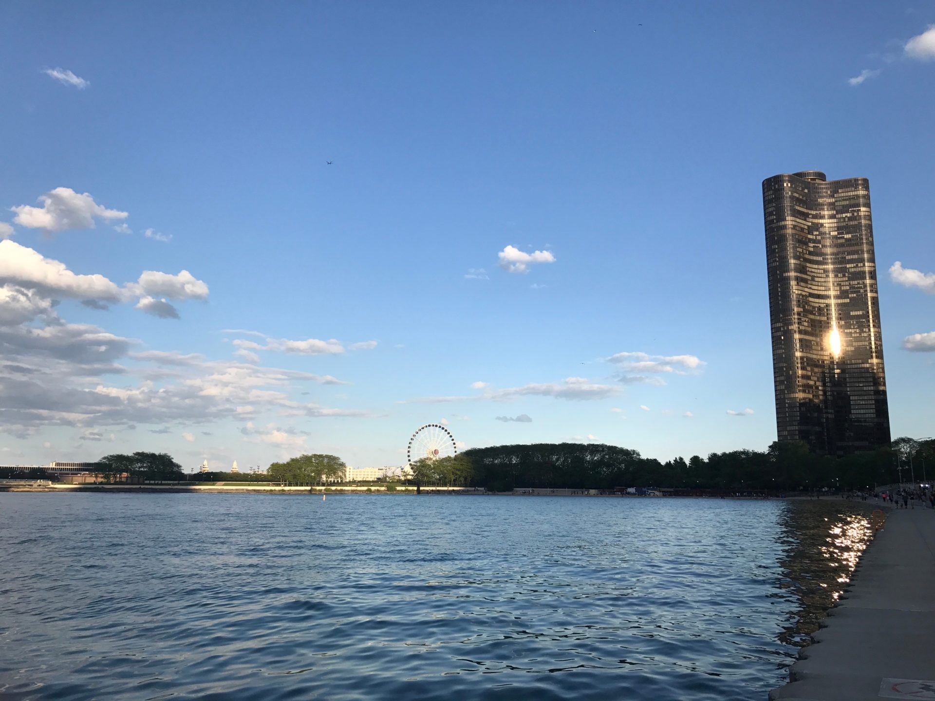 a water body with a tall building in the background