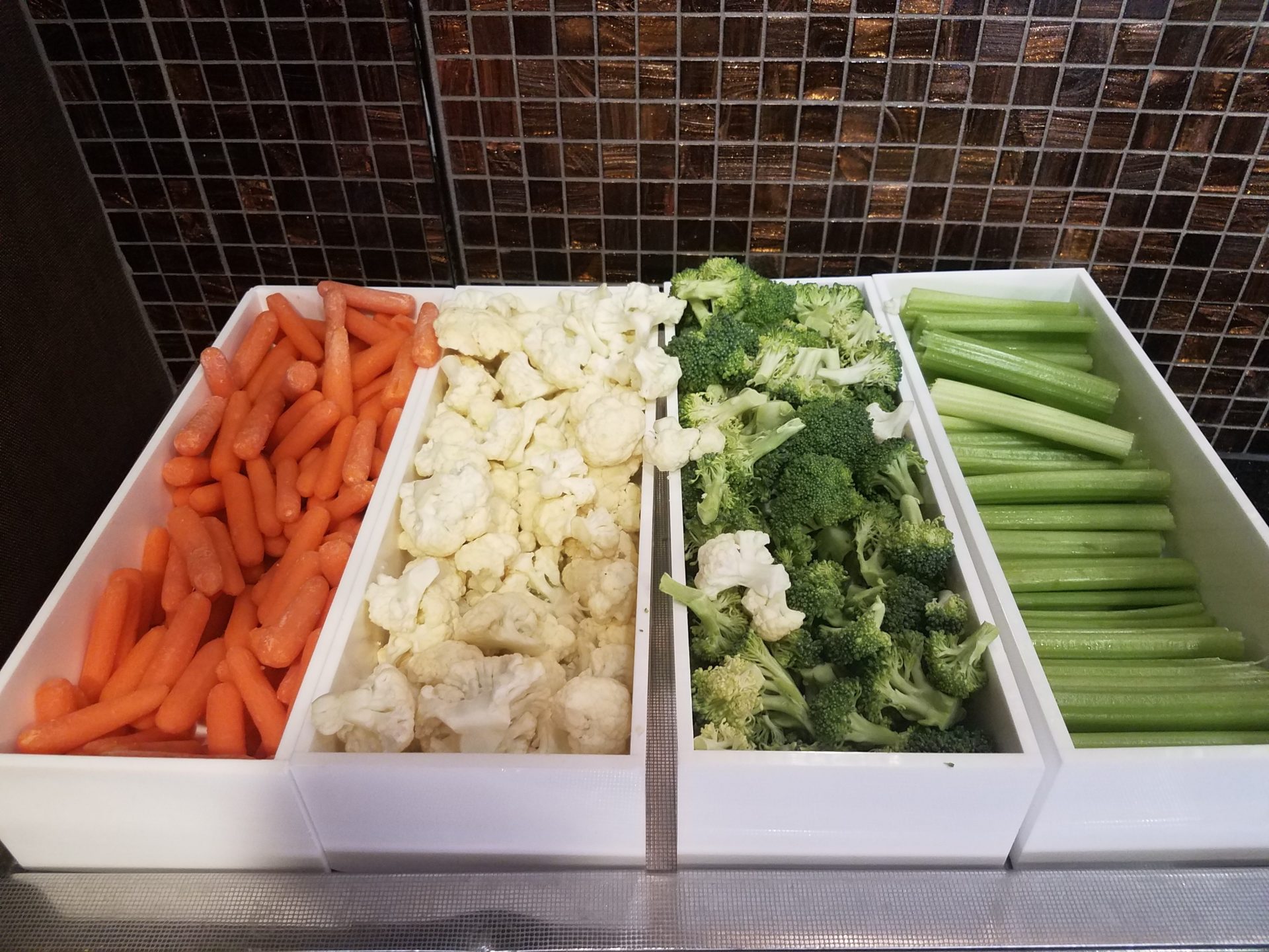 a trays of vegetables in a row