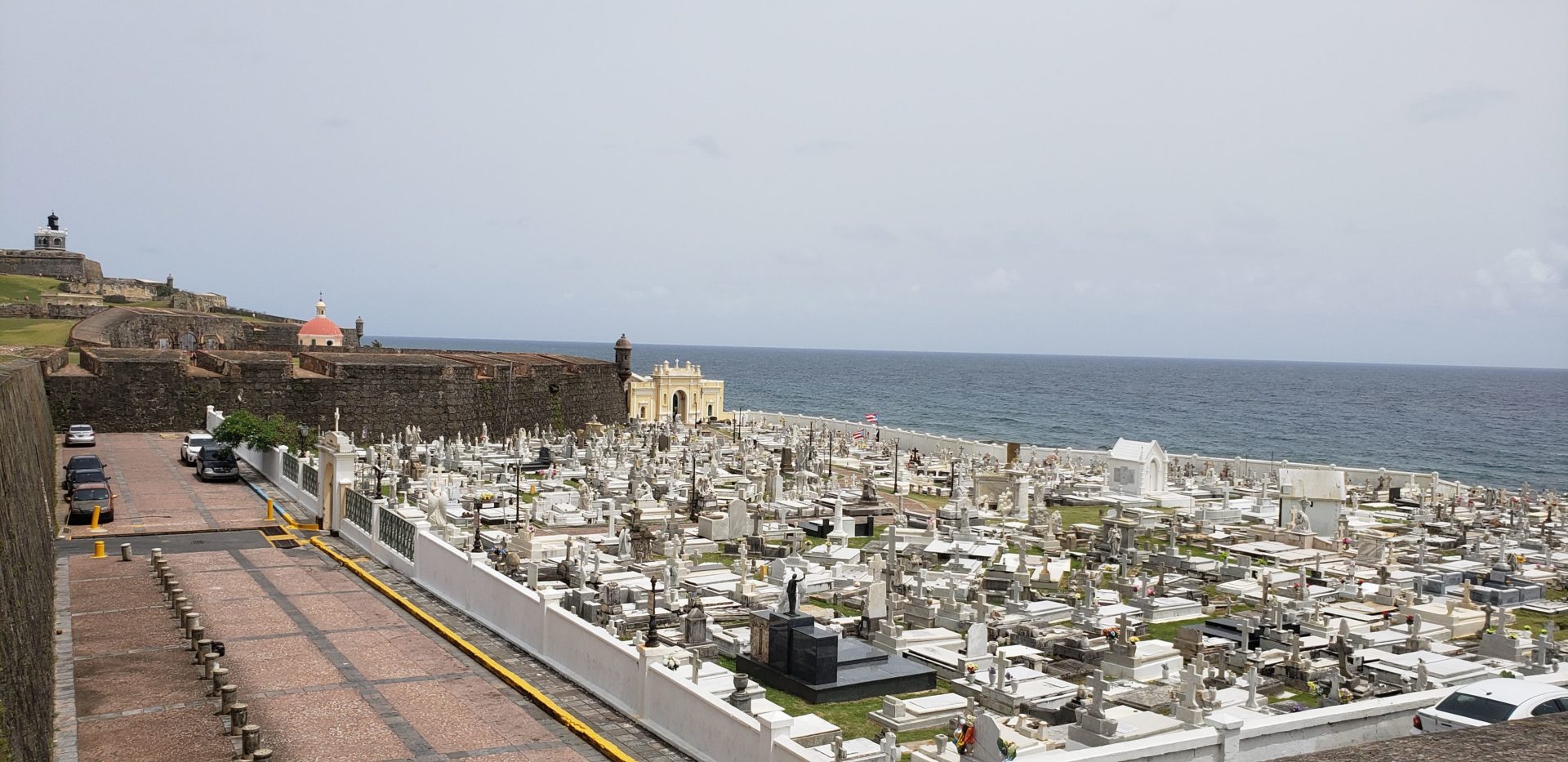 a cemetery with a body of water in the background