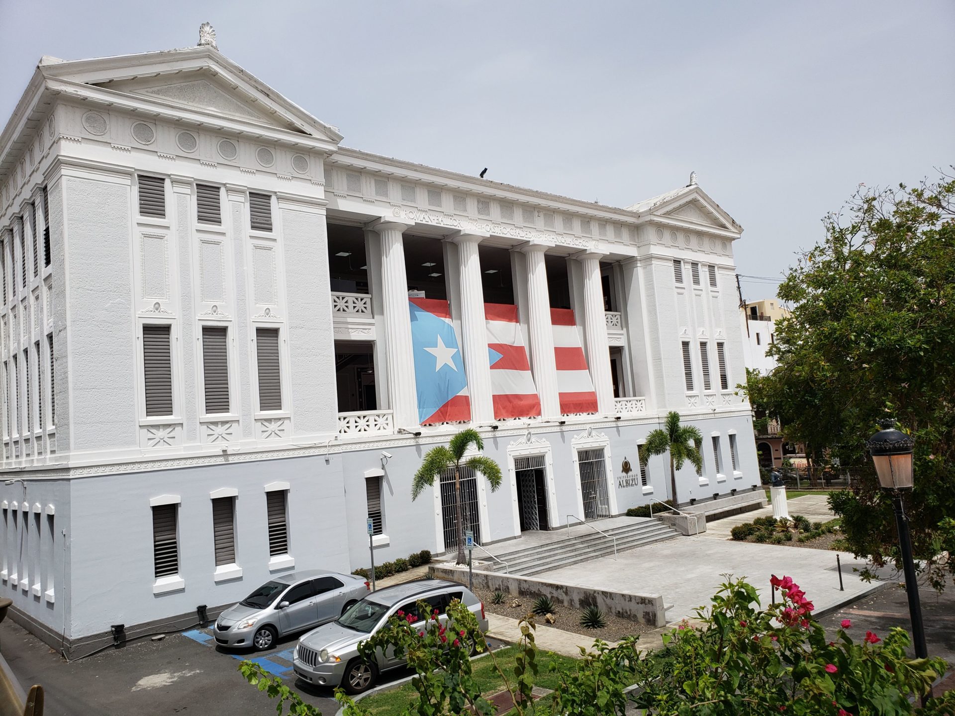 a white building with a flag on the front