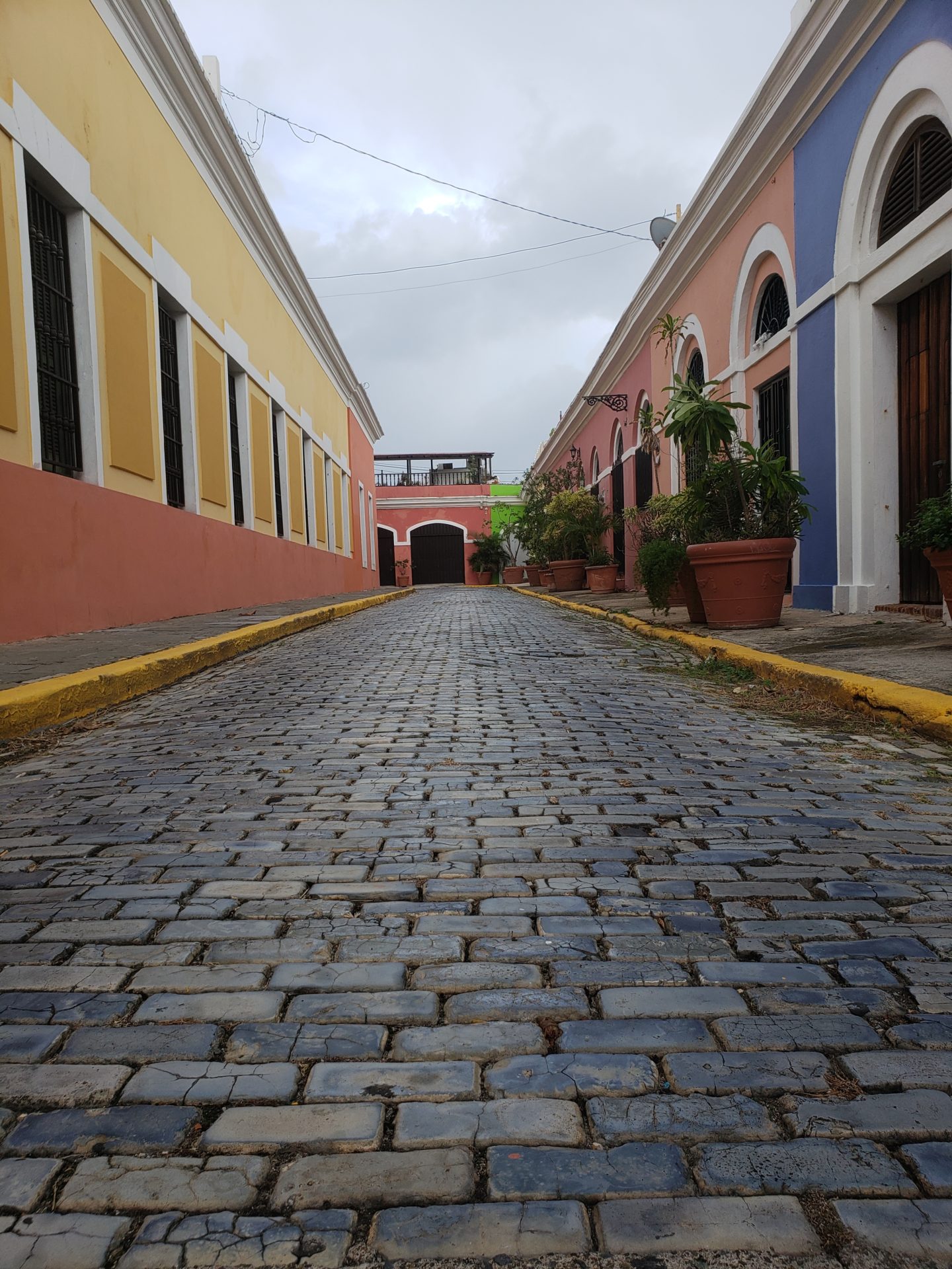 a brick road with colorful buildings