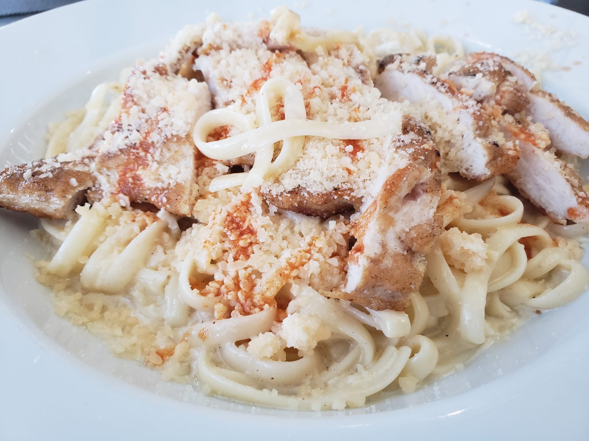 a plate of pasta with meat and cheese