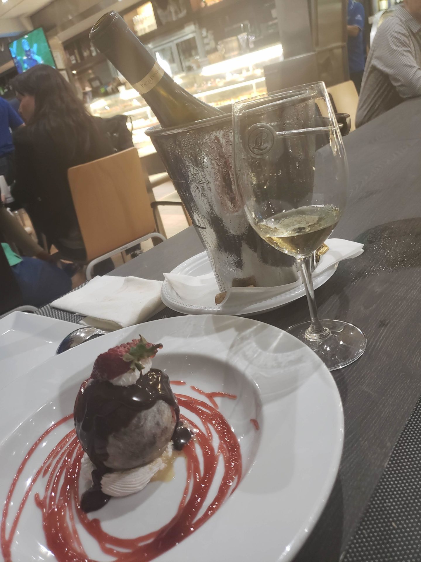 a plate of ice cream and a glass of wine