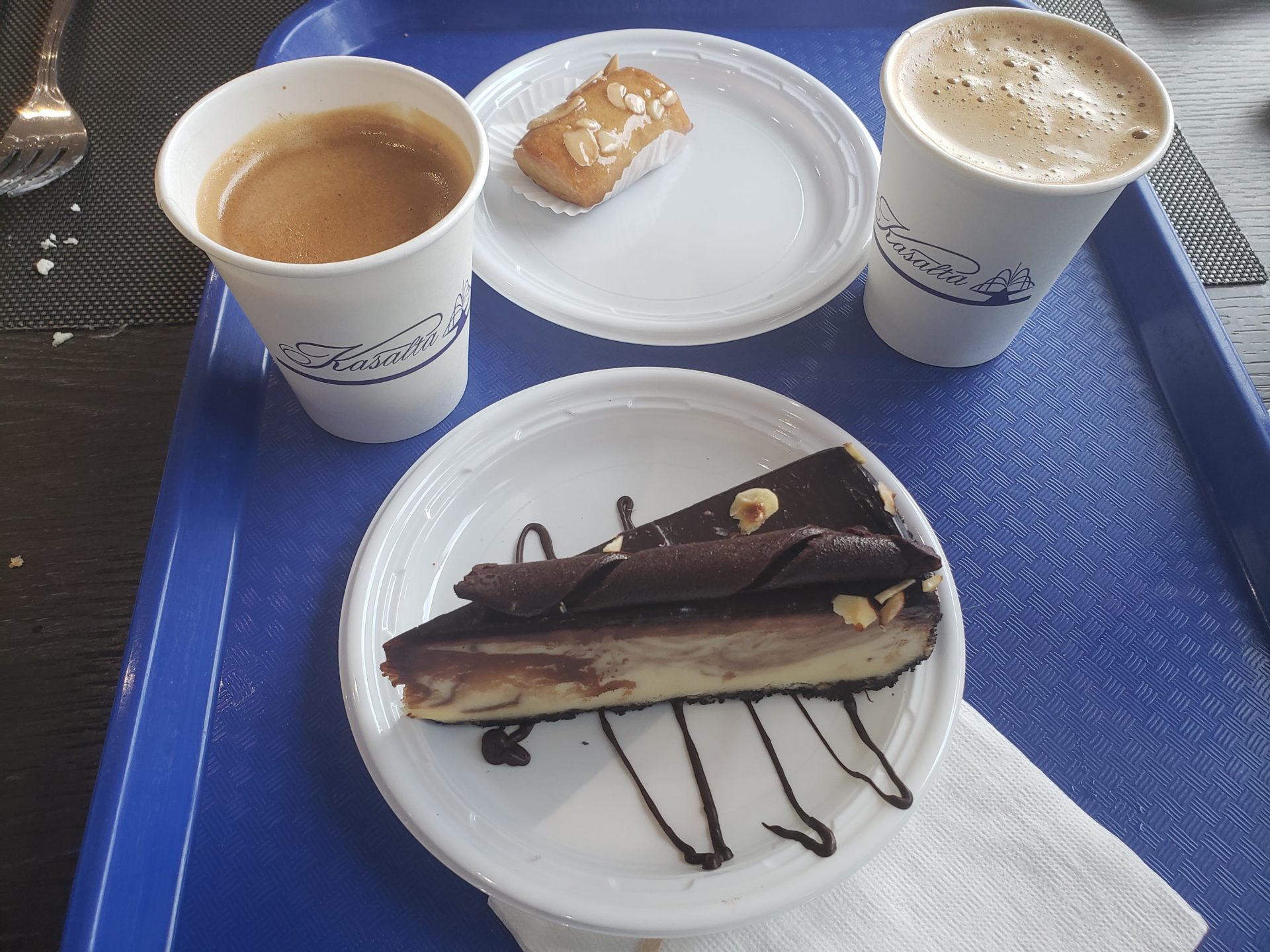 a plate of dessert and coffee on a tray