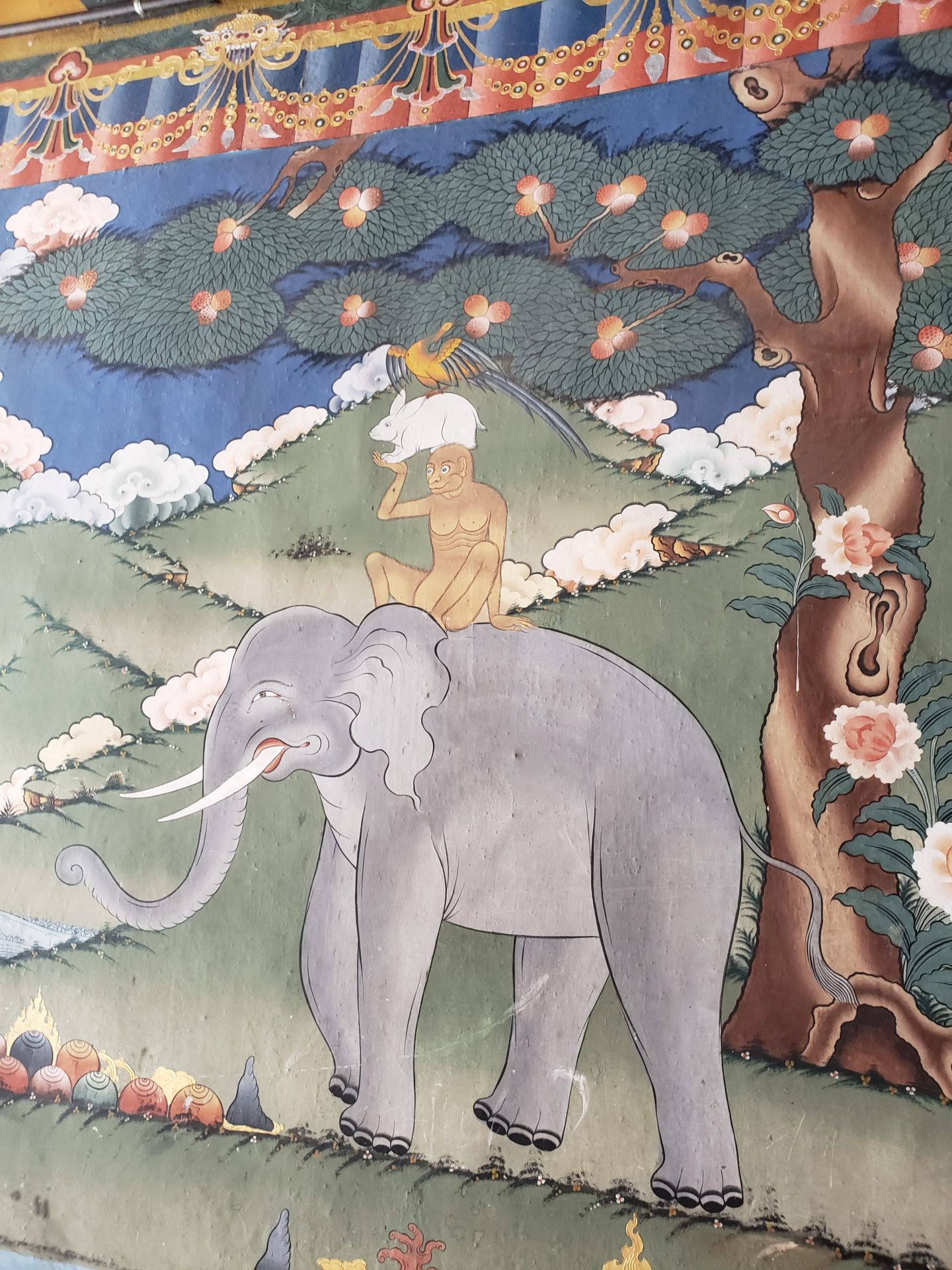a painting of an elephant and a man on a tree