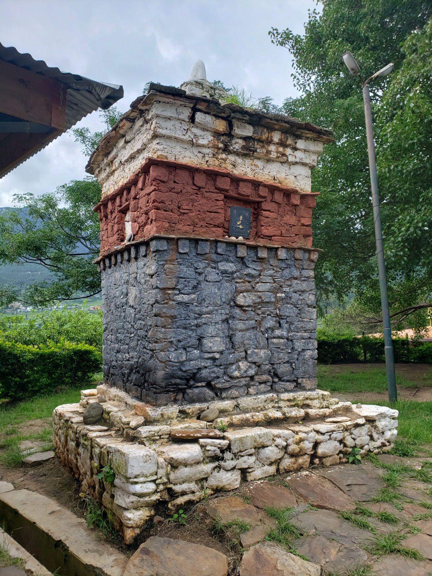 a stone structure with a small sign on it