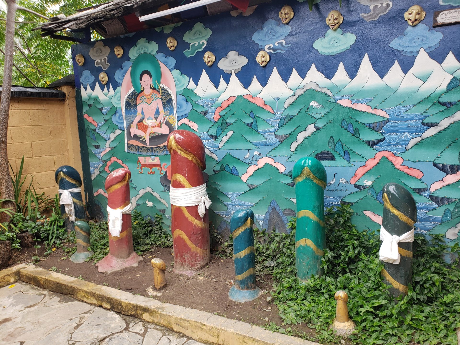 a wall with a painted wall and a group of statues