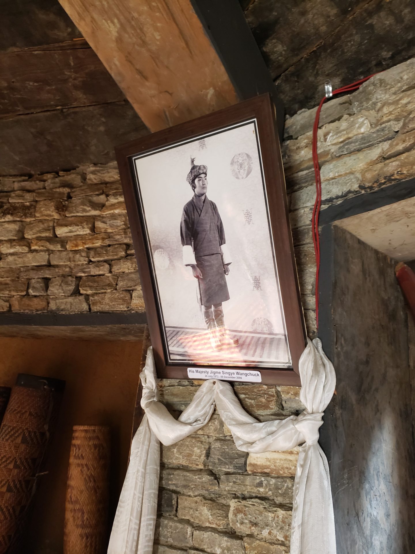 a framed picture on a stone wall