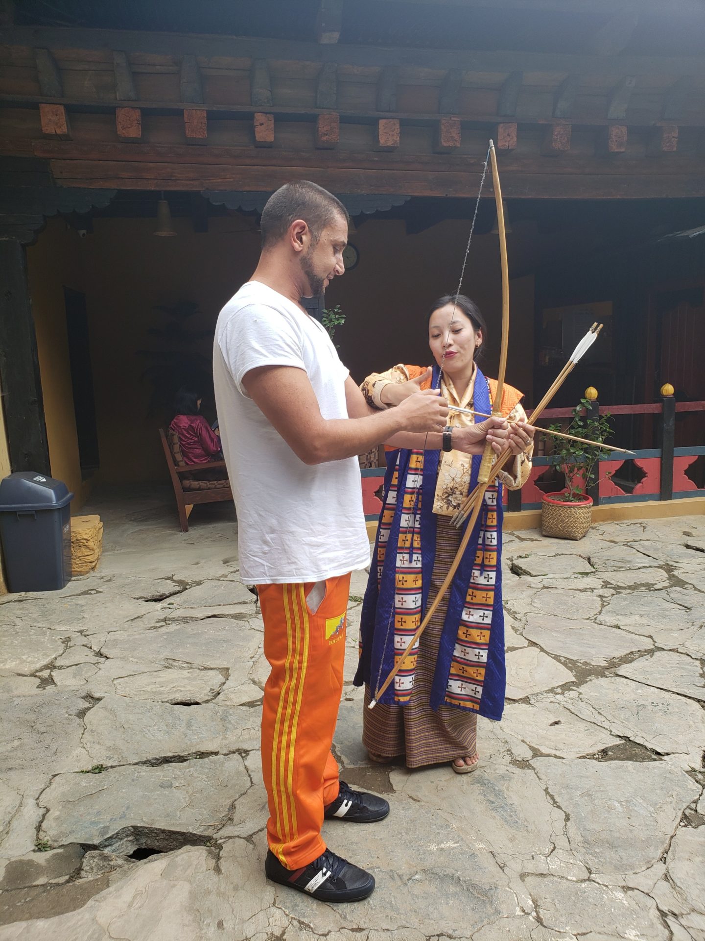 a man and woman holding a bow and arrow
