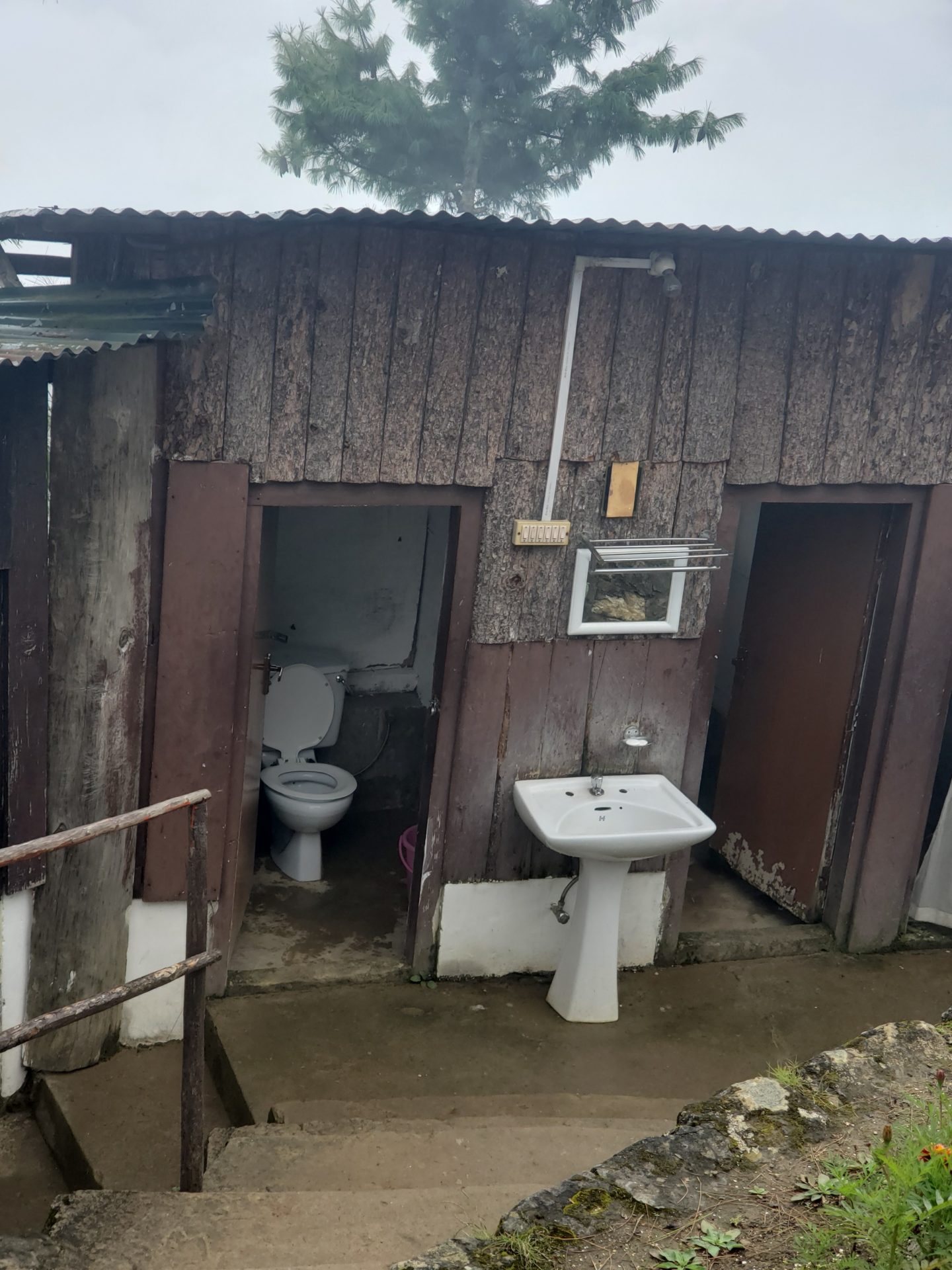 a toilet and sink outside of a cabin