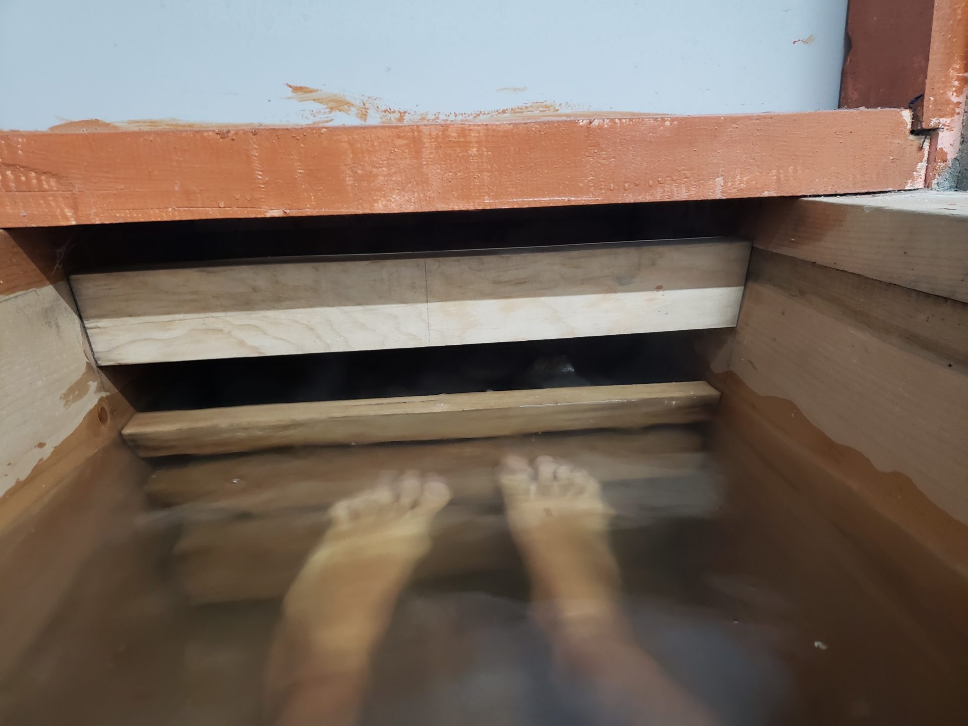 feet in water under a wooden step