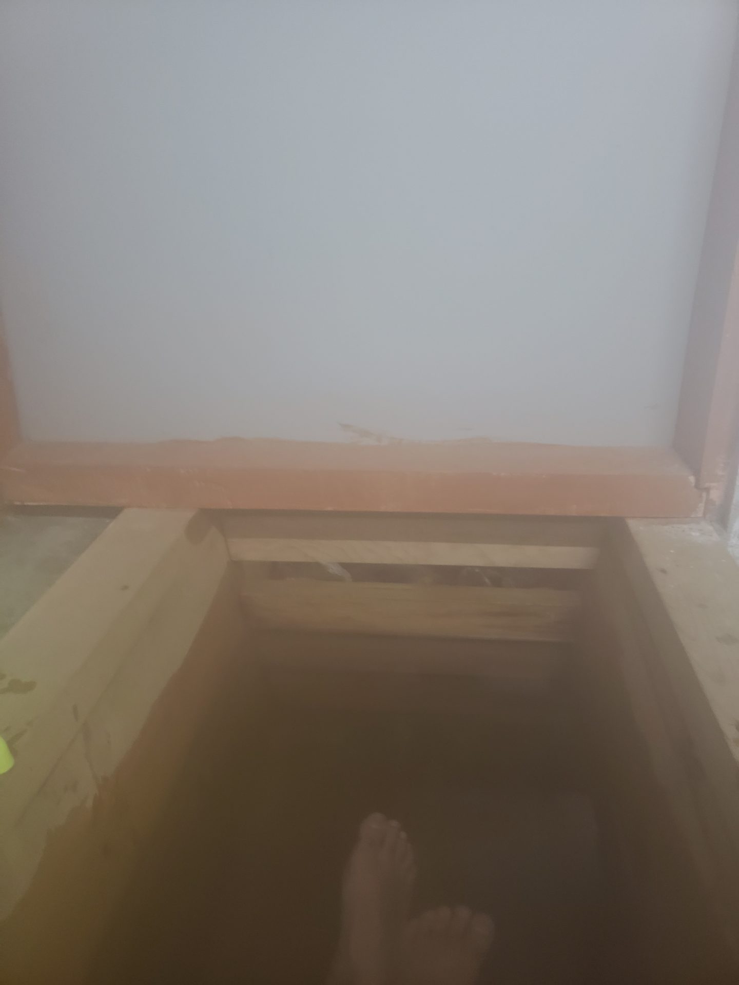 a person standing in a hole in a room