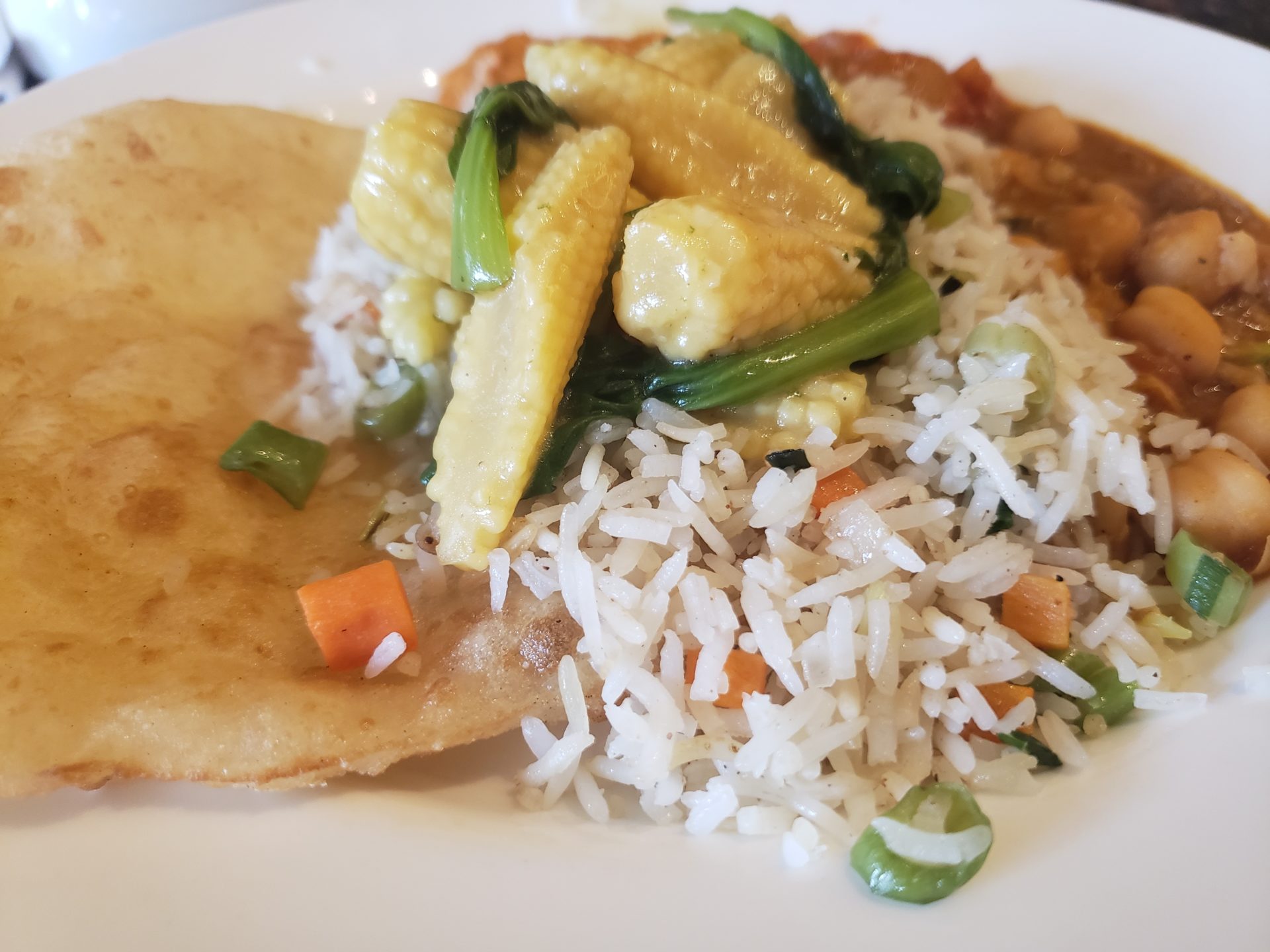 a plate of food with rice and vegetables