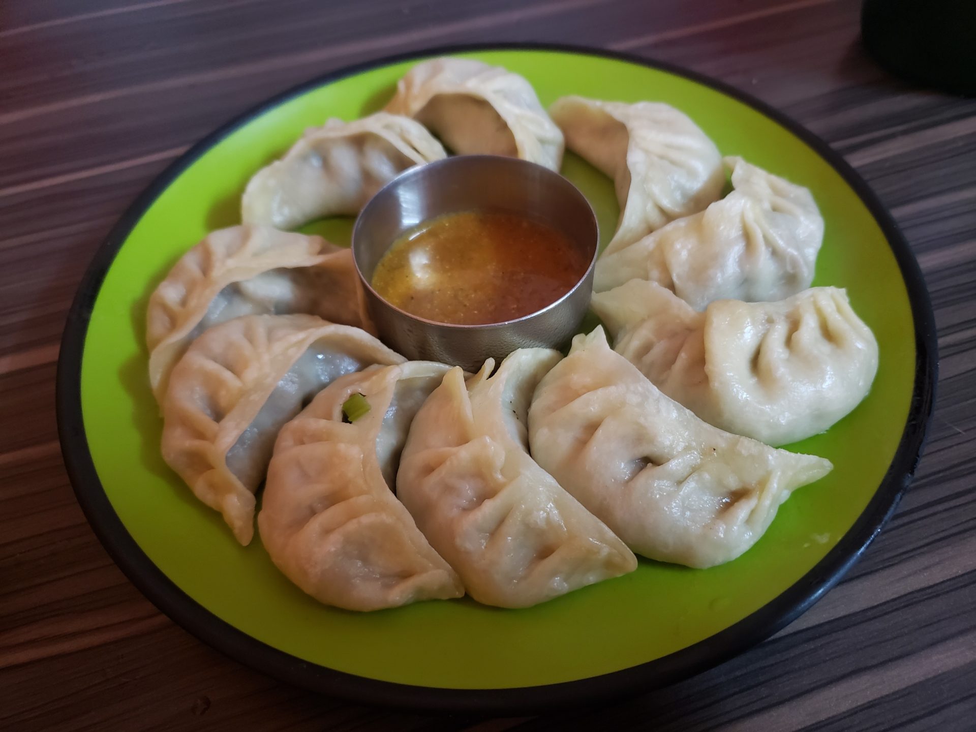 a plate of dumplings with sauce