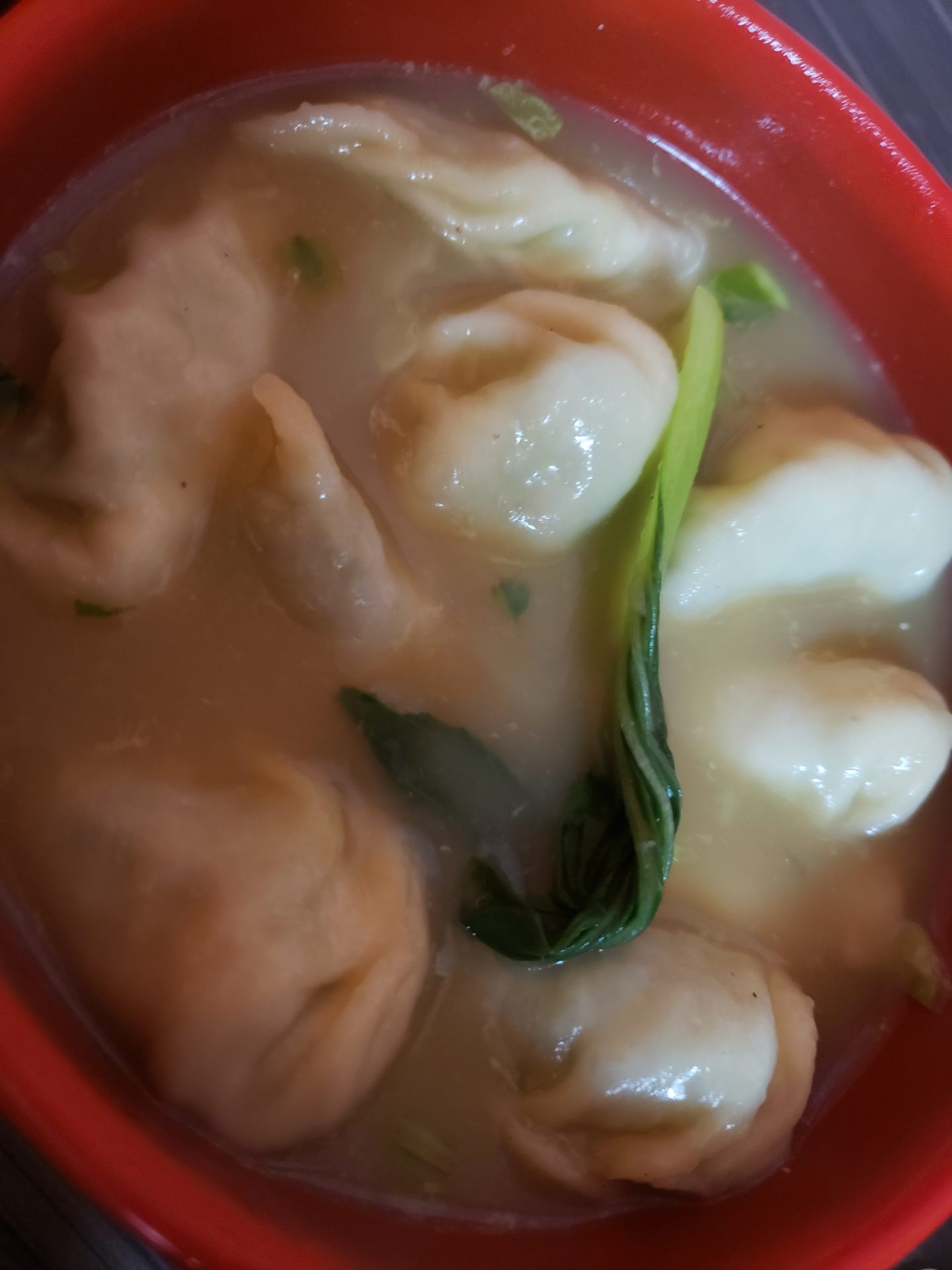 a bowl of soup with dumplings