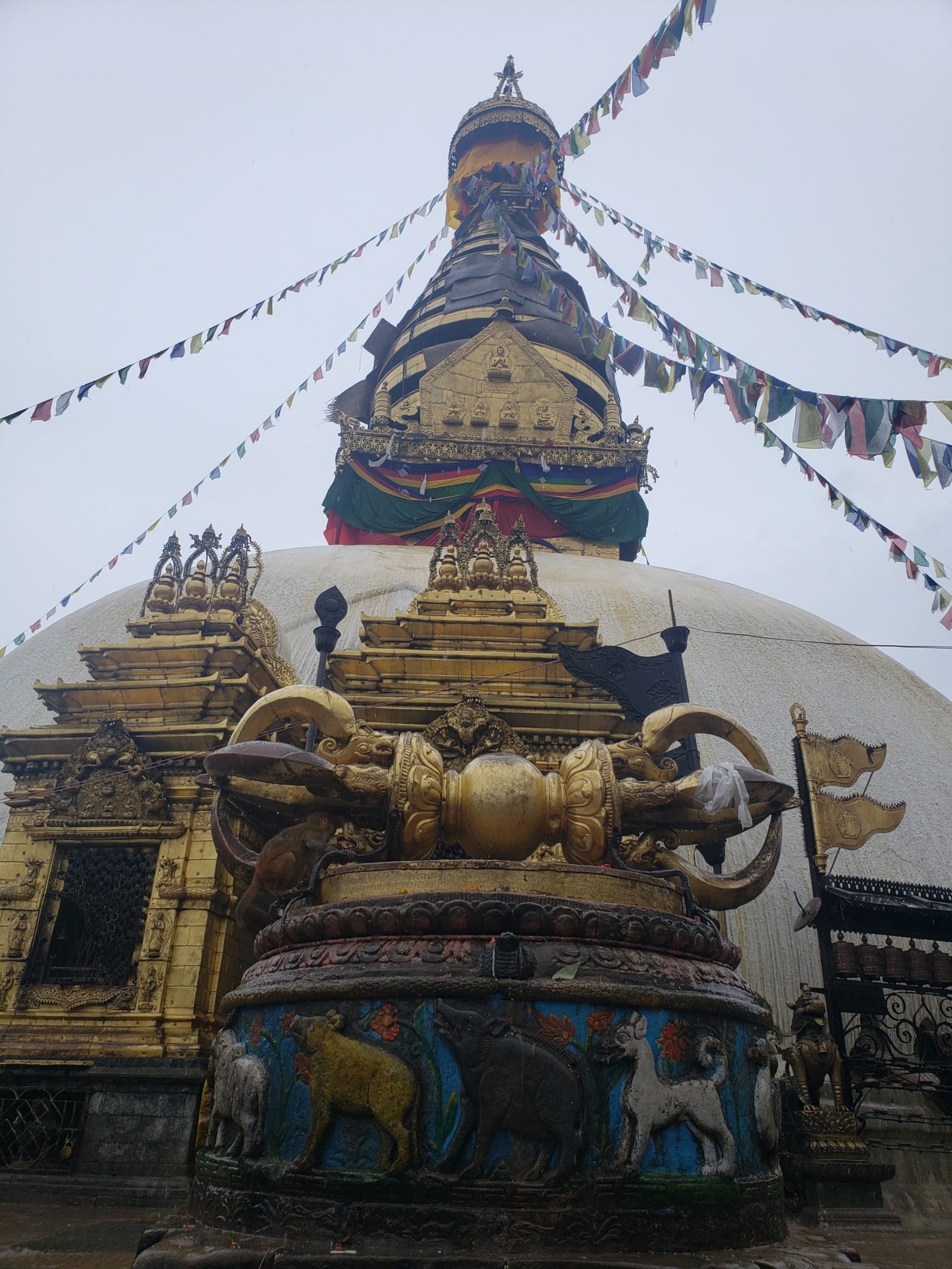 a large building with Swayambhunath and flags